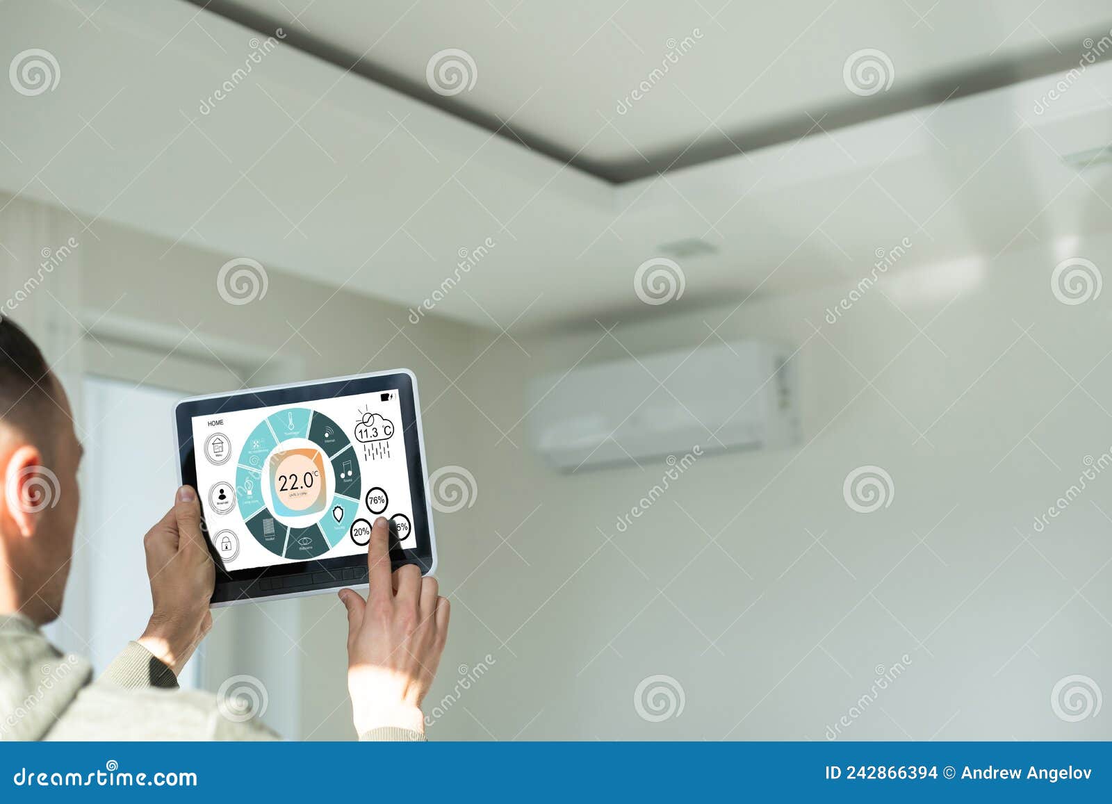 Manipulating Air Conditioner with Tablet. Stock Photo Image of
