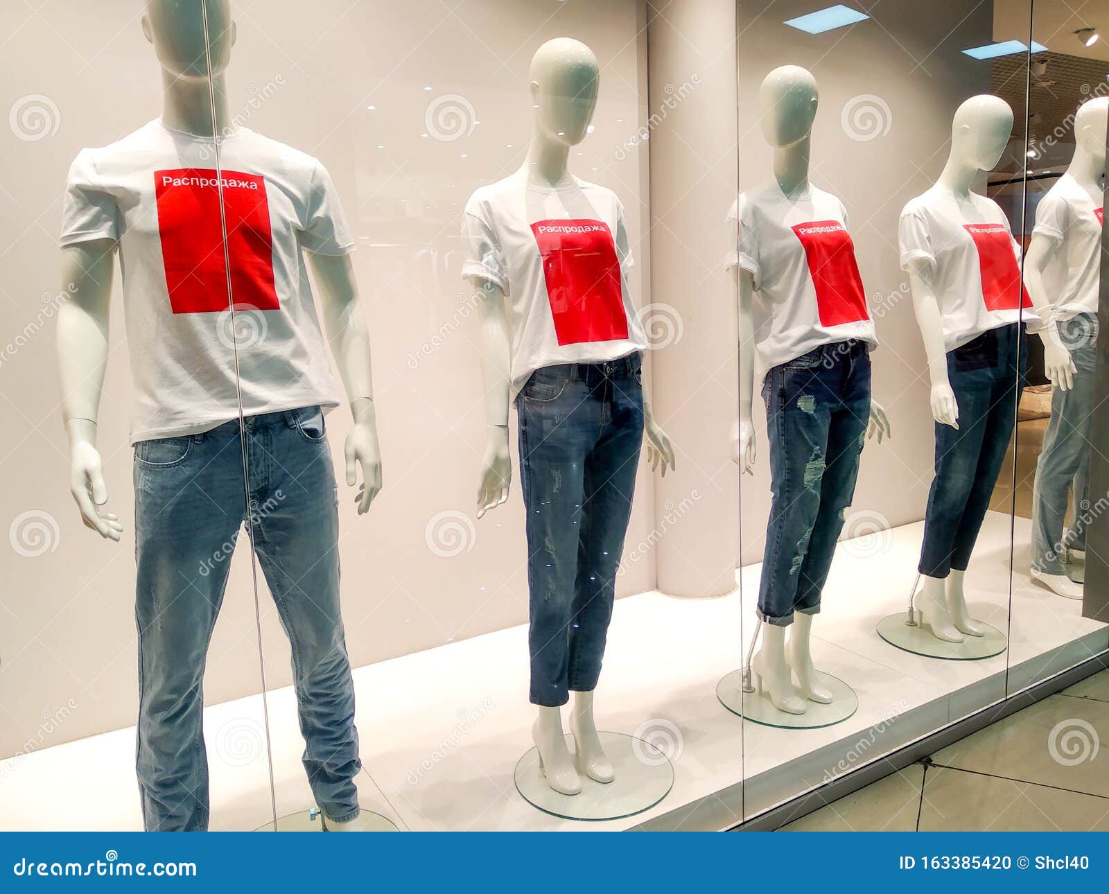 Mannequins Wearing White Tshirts with Red Text Sale in Window Clothing ...