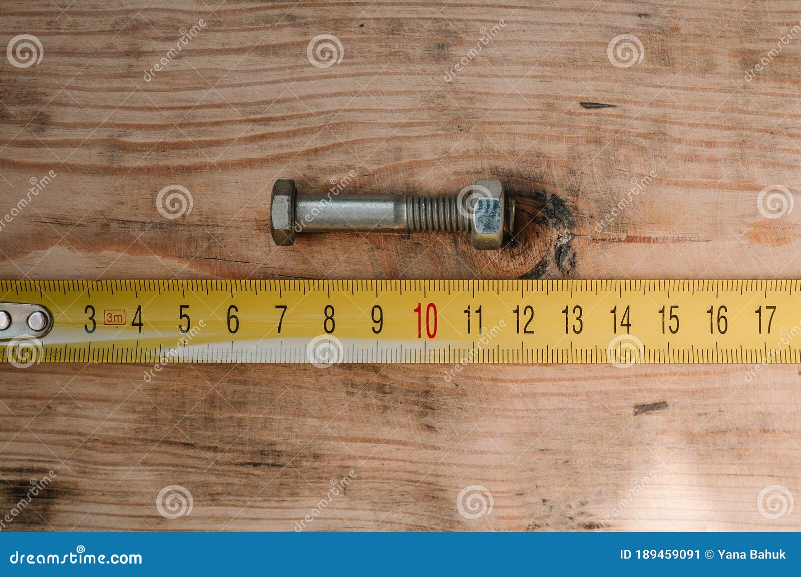 mans hands working with wood measuring tape