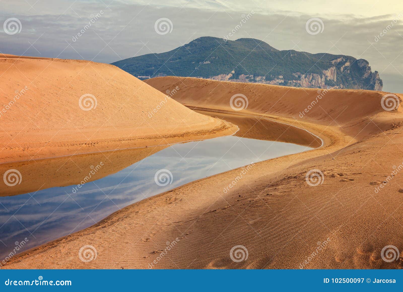 mantilla river flows into the sea between dunes in laredo, cantabria, spain
