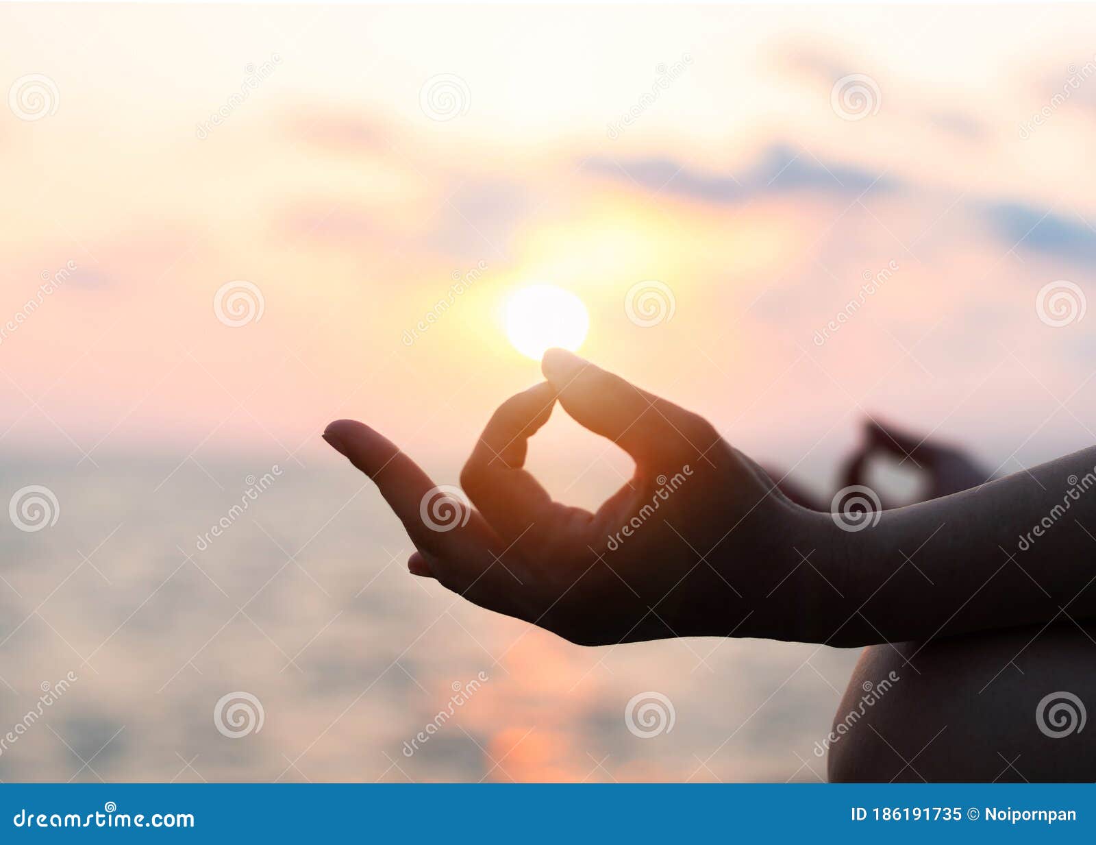 mantra yoga meditation practice with silhouette of woman in lotus pose having peaceful mind relaxation on the beach