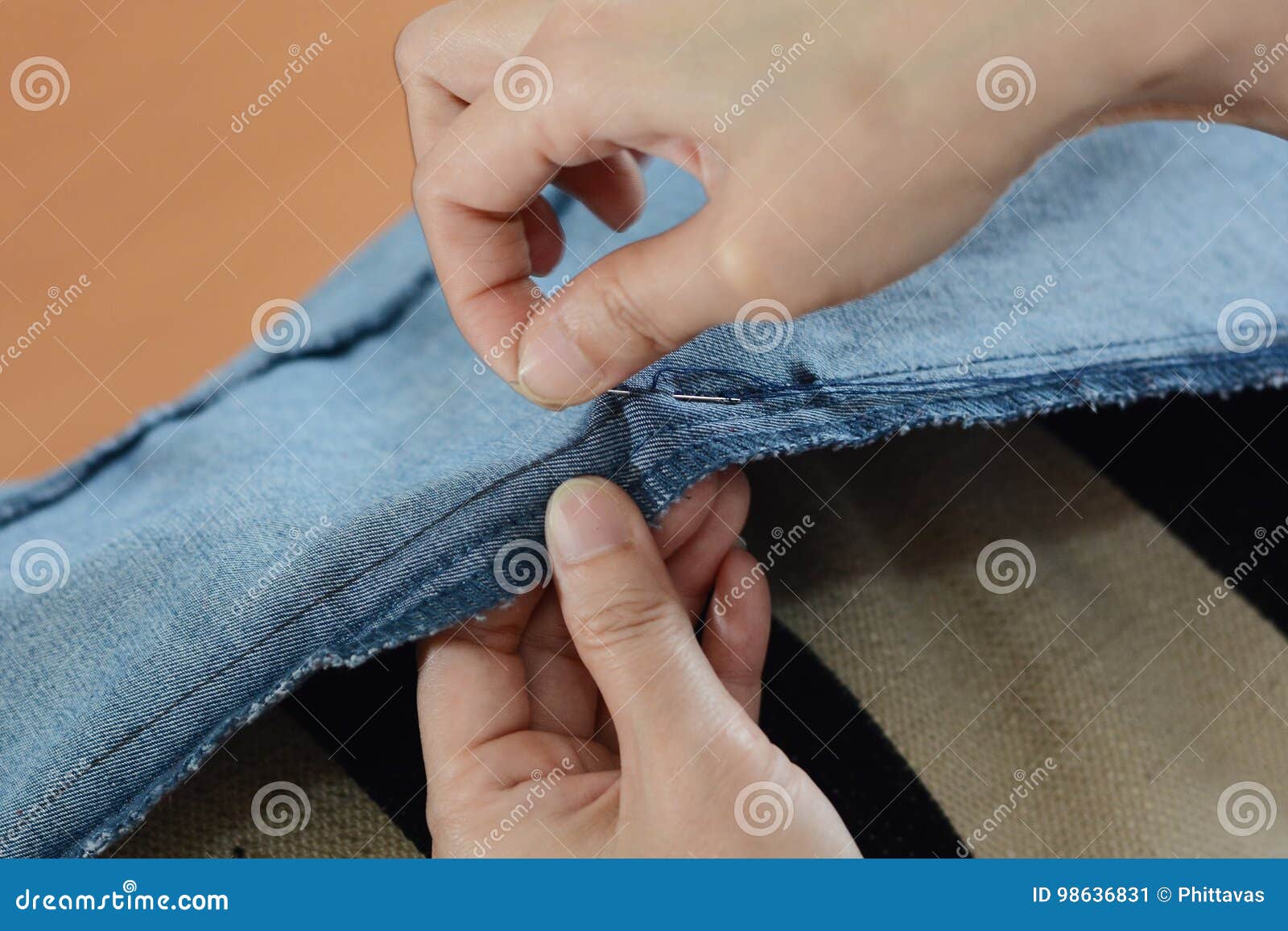 Manual Sewing Moment by Hands Inserting the Needle in Fabric Stock