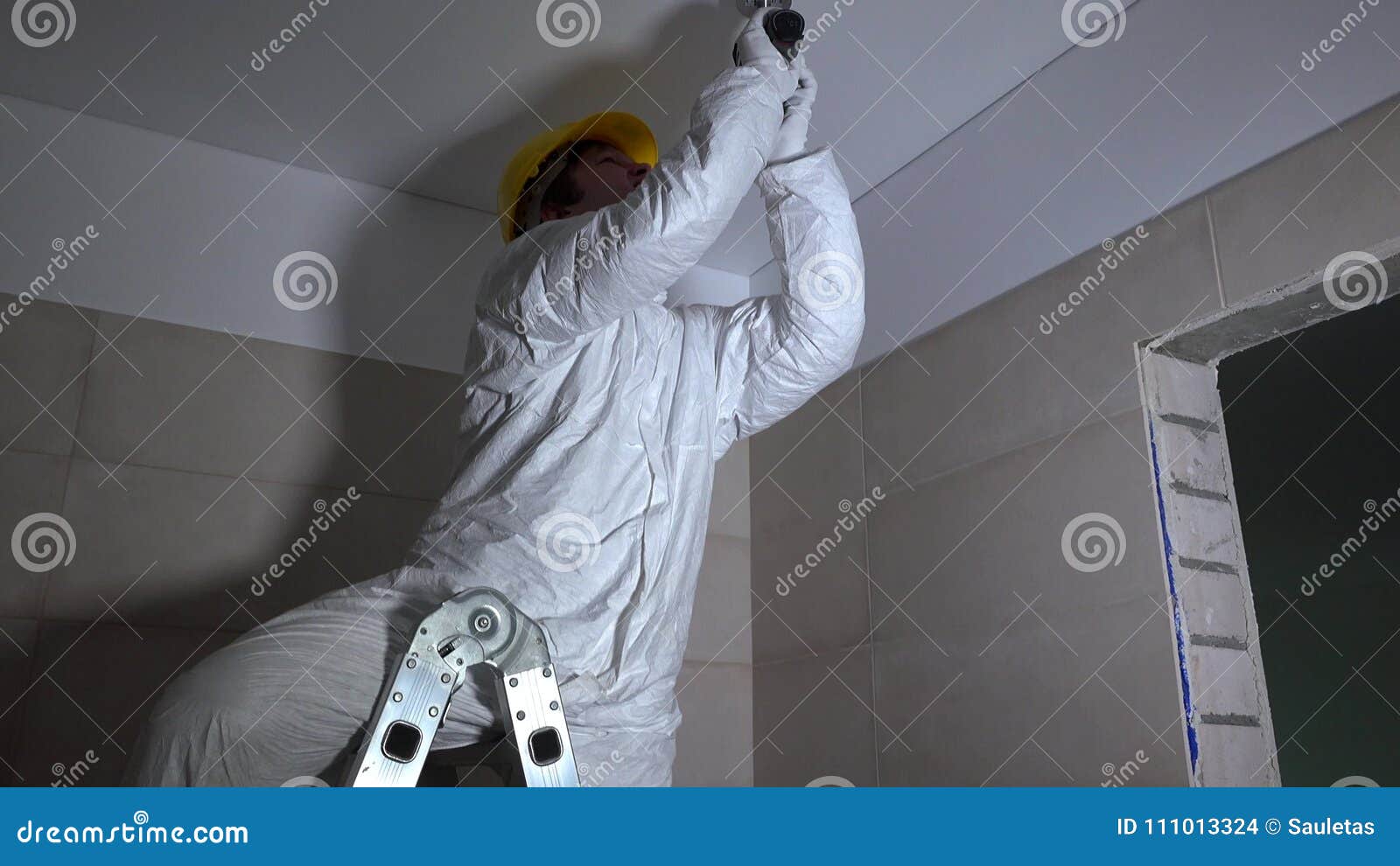 Manual Worker Drilling Hole In Ceiling Plasterboard For Led