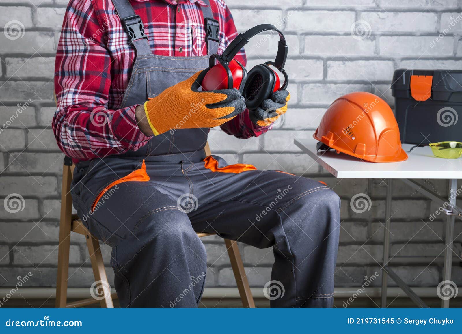 . manual worker putting protective headphones.