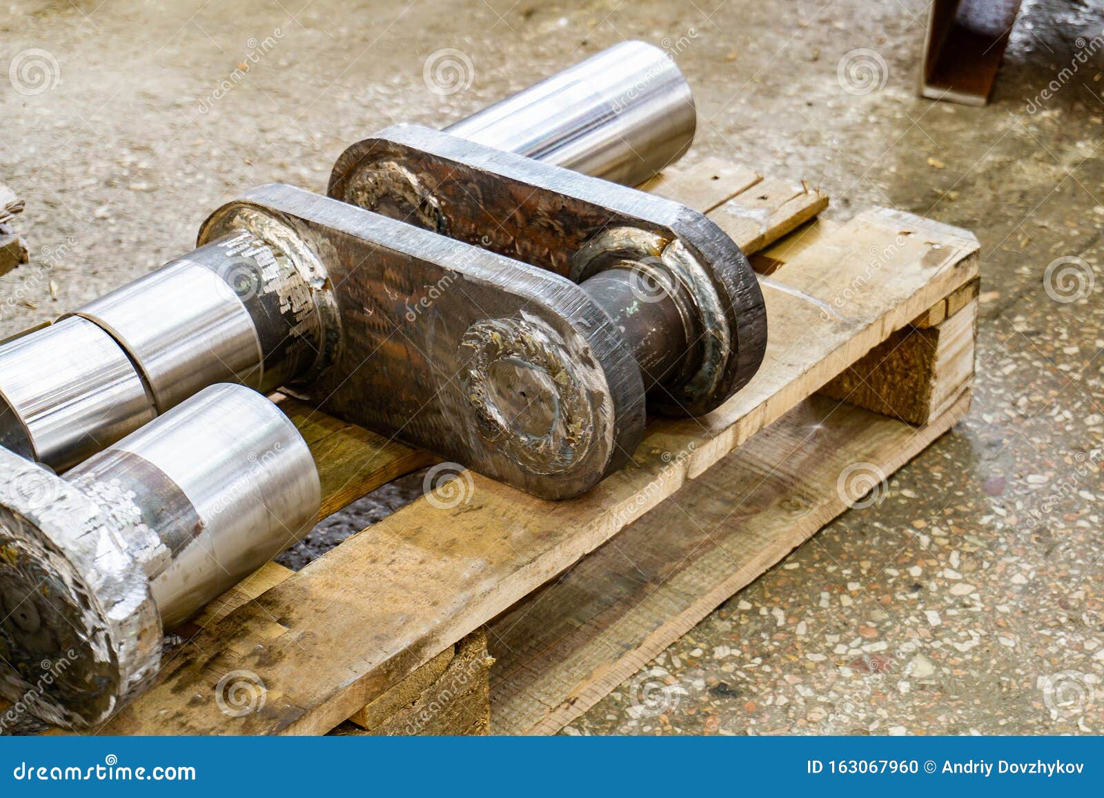 After Manufacturing, the Industrial Crankshaft Rests on the Rack in the Warehouse Stock Photo