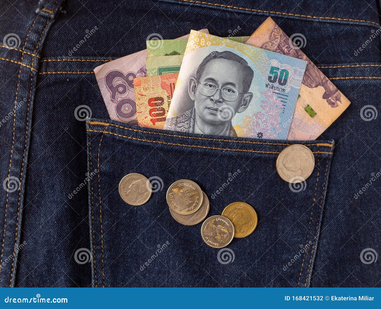 Many Baht Banknote And Coins Of Thailand In The Back Pocket Blue Jeans many-baht-banknote-and-coins-of-thailand-in-the-back-pocket-blue-jeans