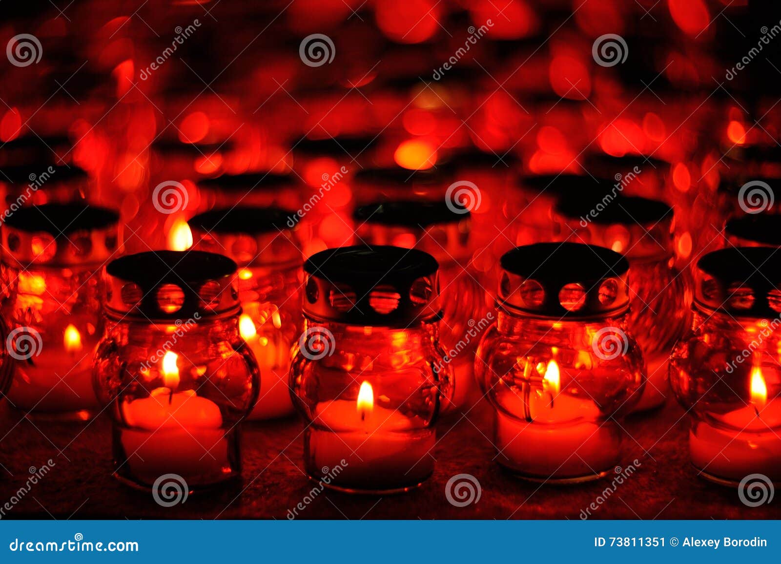 Many Candles Burning in Red Candle Holders at Night Stock Image Image