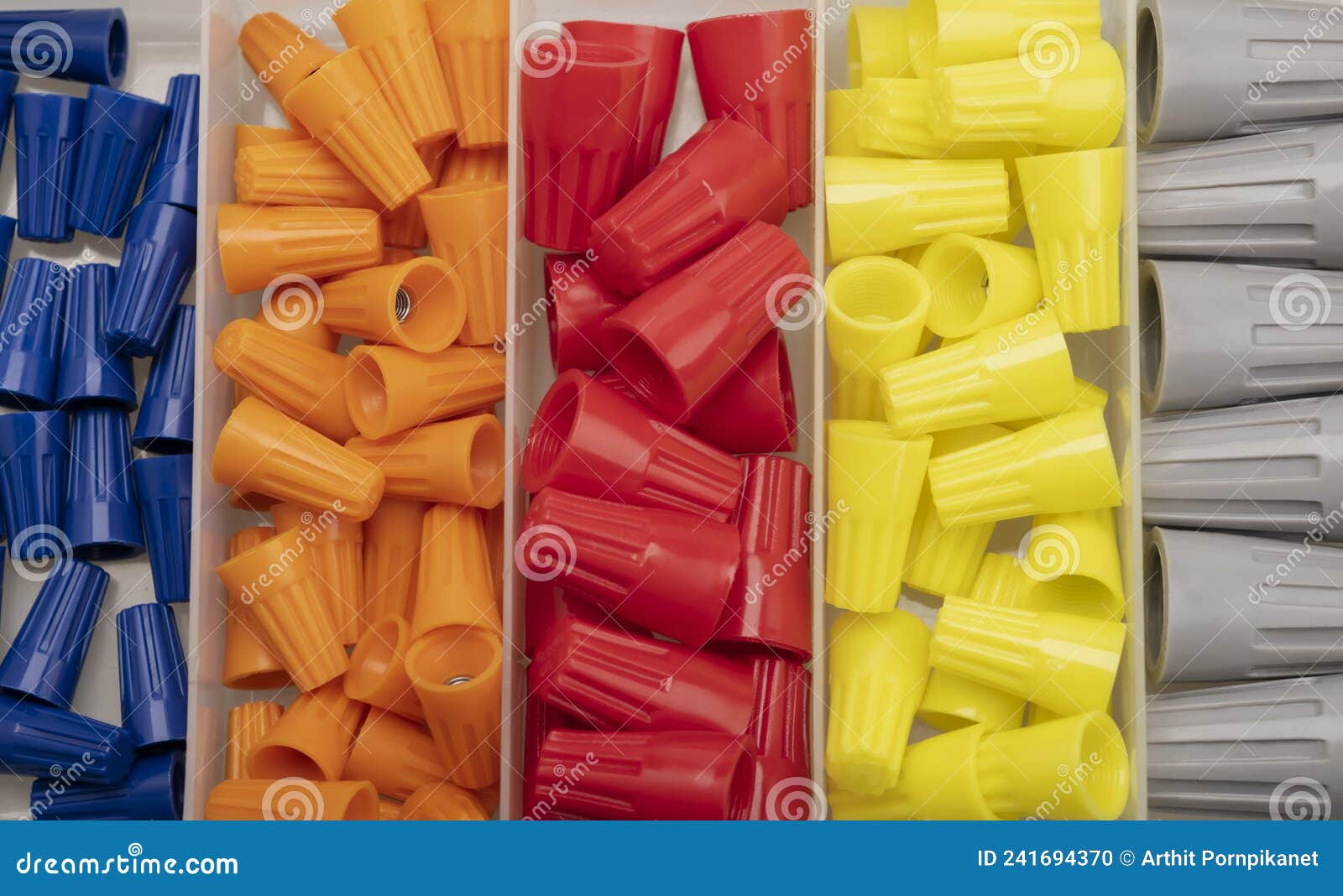 Many Colored Wire Nuts in Plastic Box on White Background , Tool for