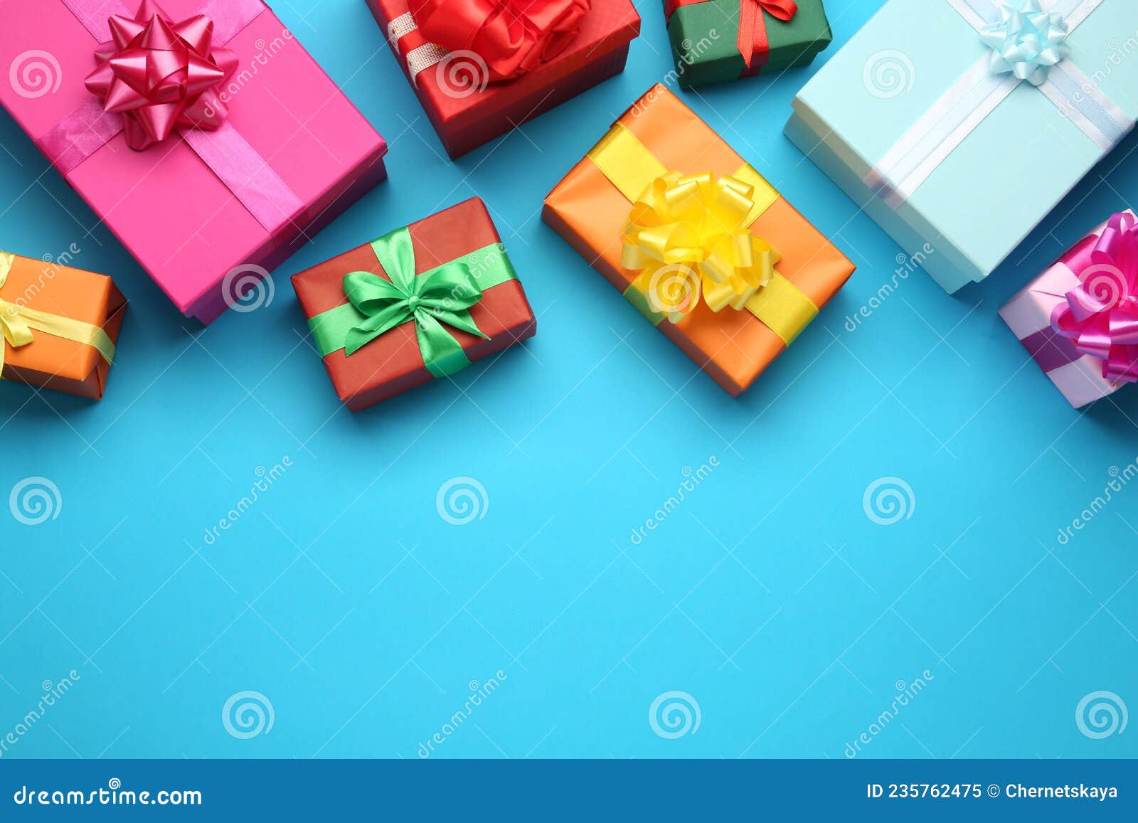 Many Colorful Gift Boxes on Light Blue Background, Flat Lay. Space for