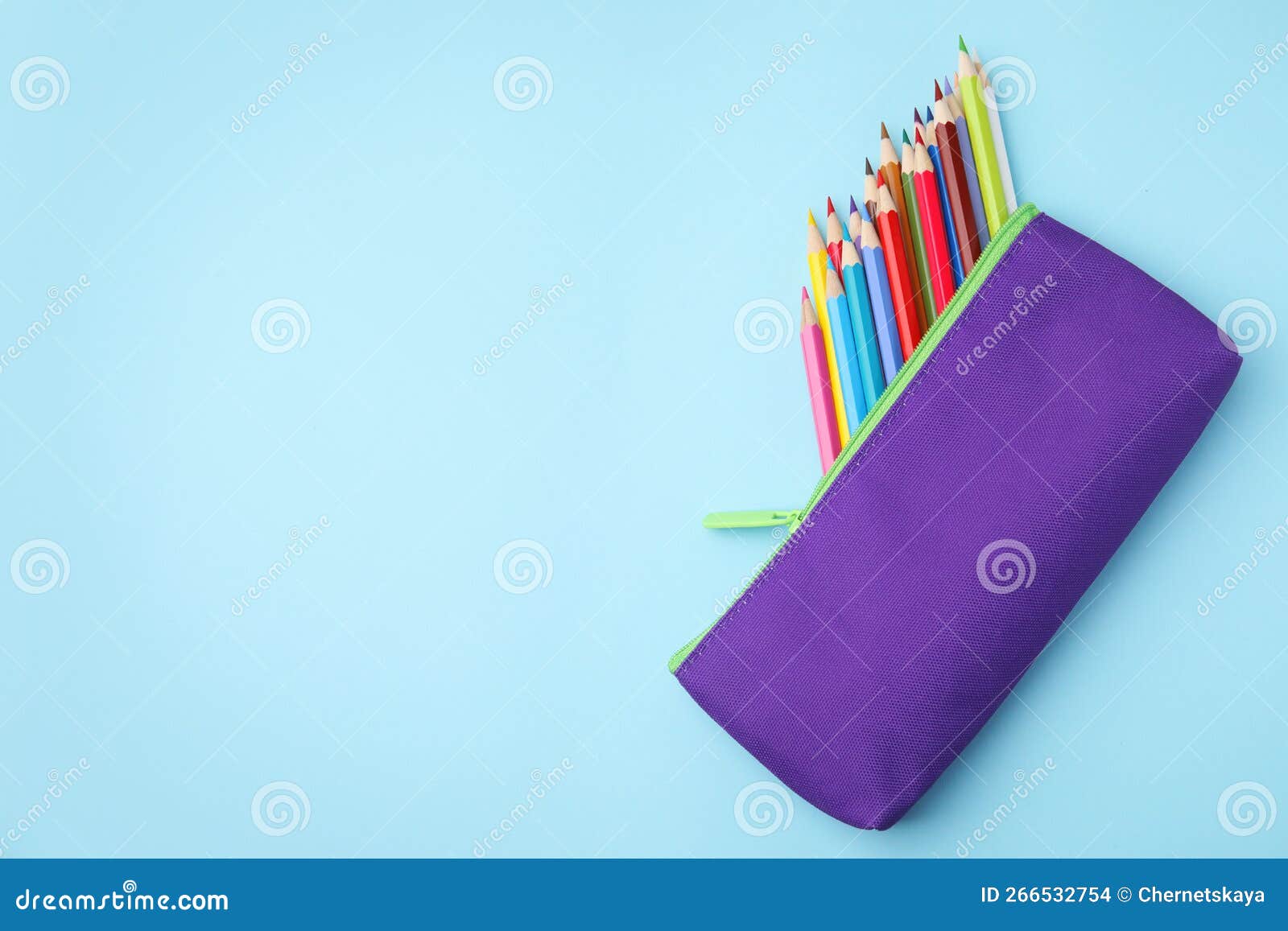 Many Colorful Pencils in Pencil Case on Light Blue Background, Top View