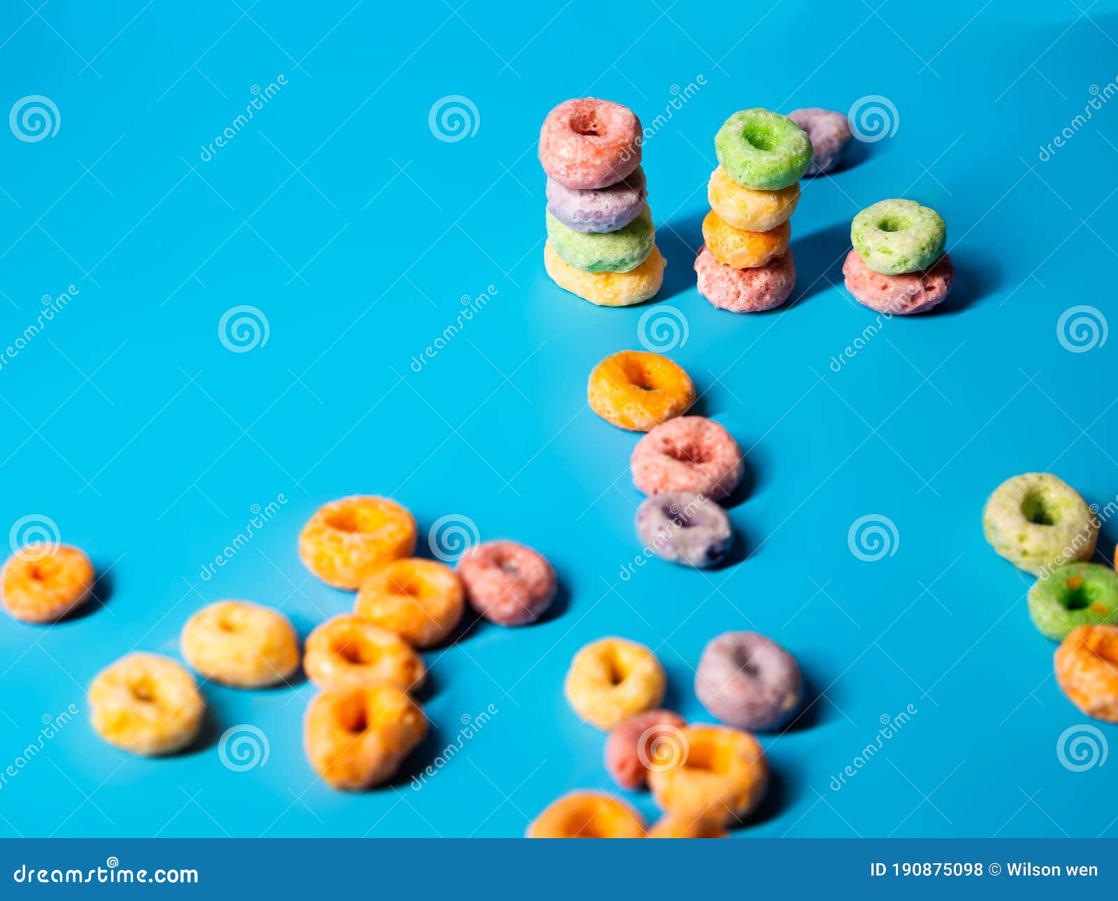 Many Colorful Sugary Cereal Grains On A Blue Background Stock