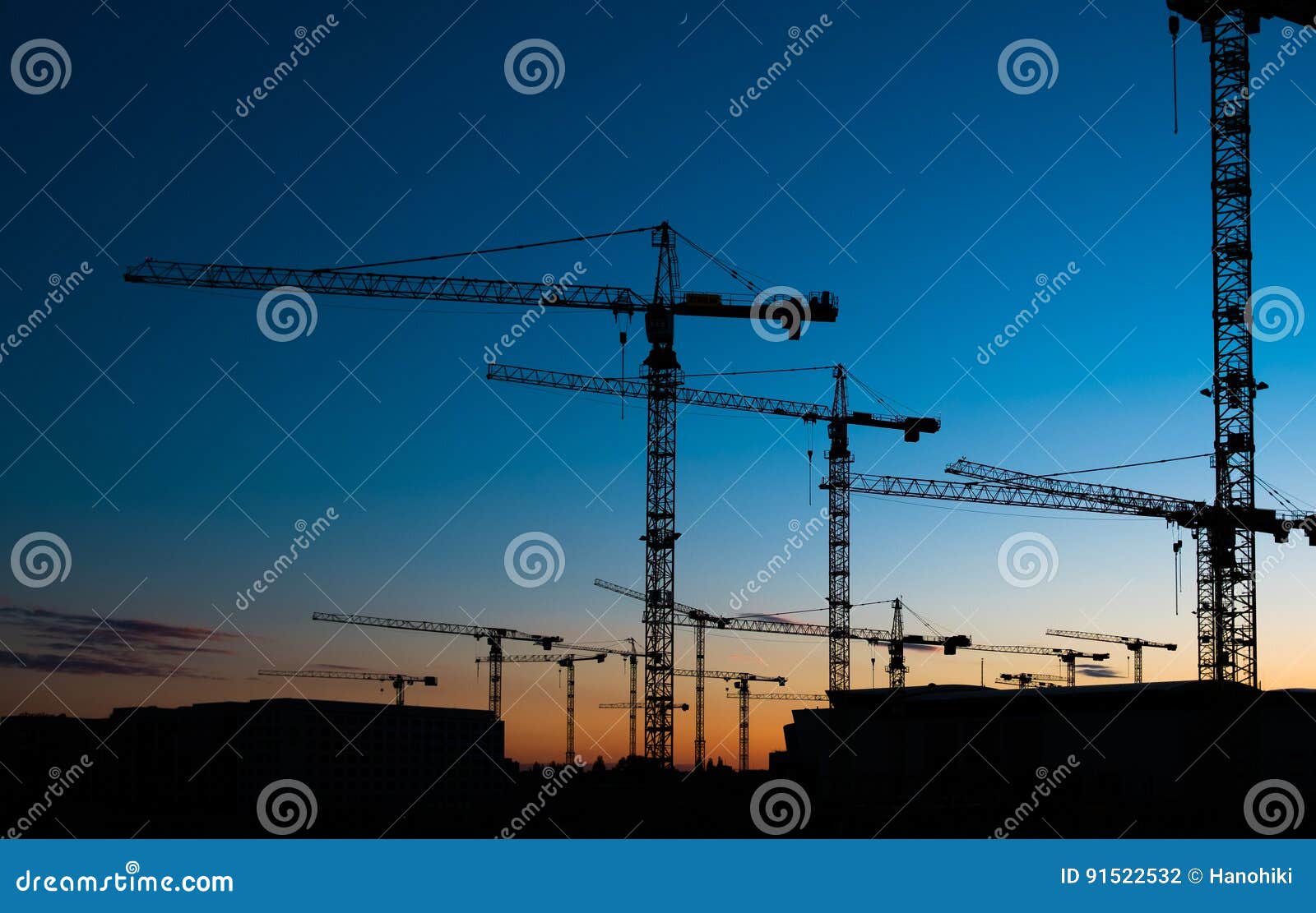 many construction cranes on sunset sky , crane silhouette skyline