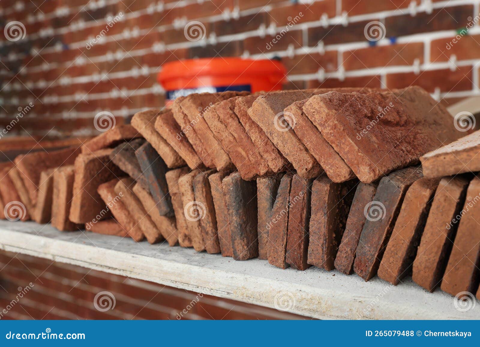 Many Decorative Bricks on Scaffolding Near Wall, Closeup. Tiles
