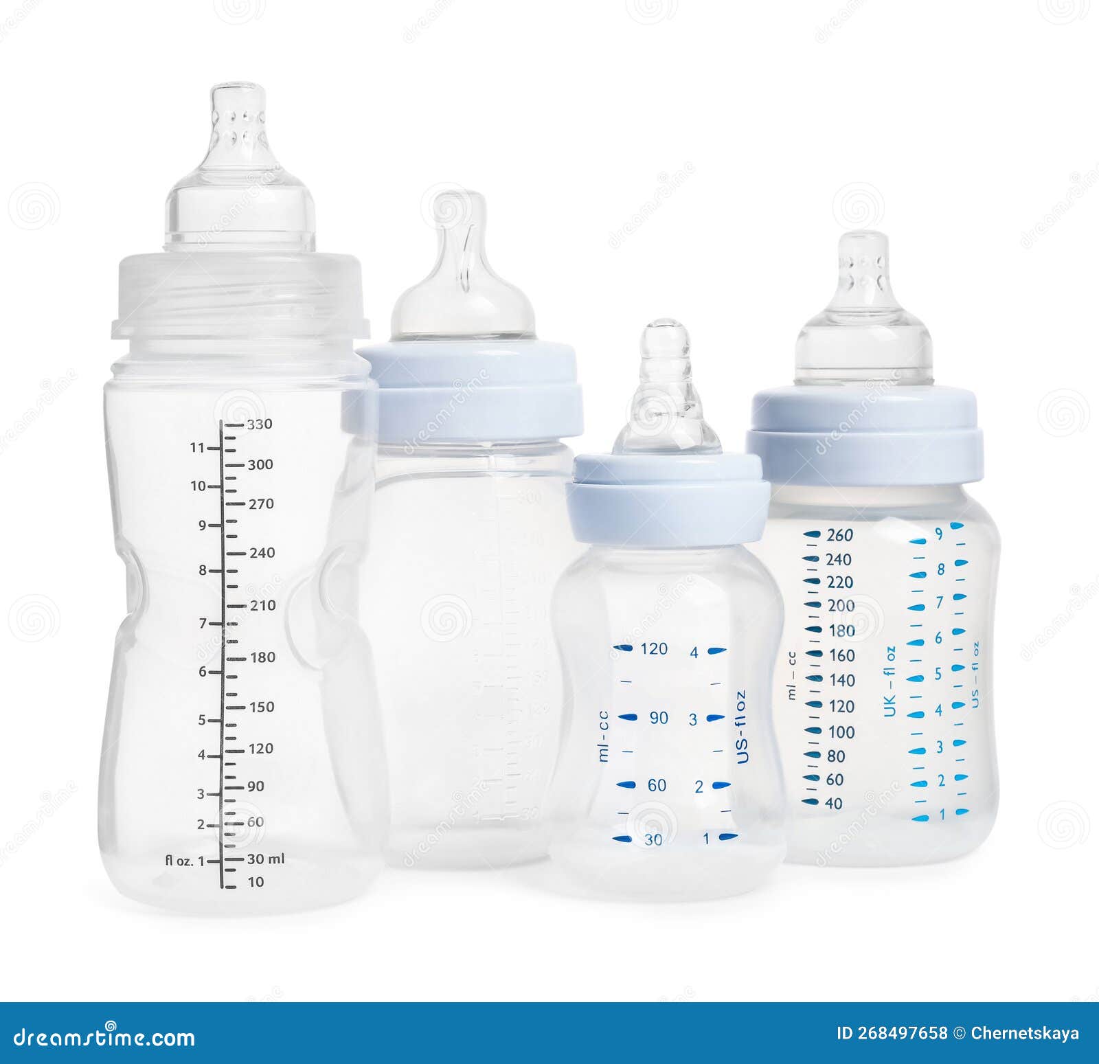 Many Different Empty Feeding Bottles for Infant Formula on White