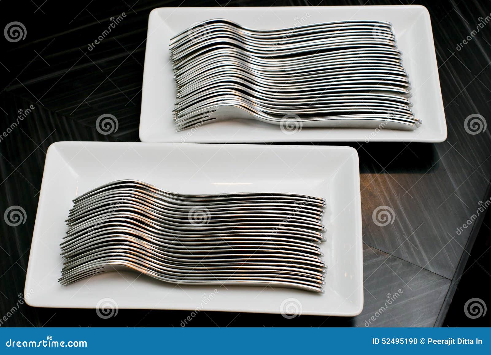 many forks on a white dish