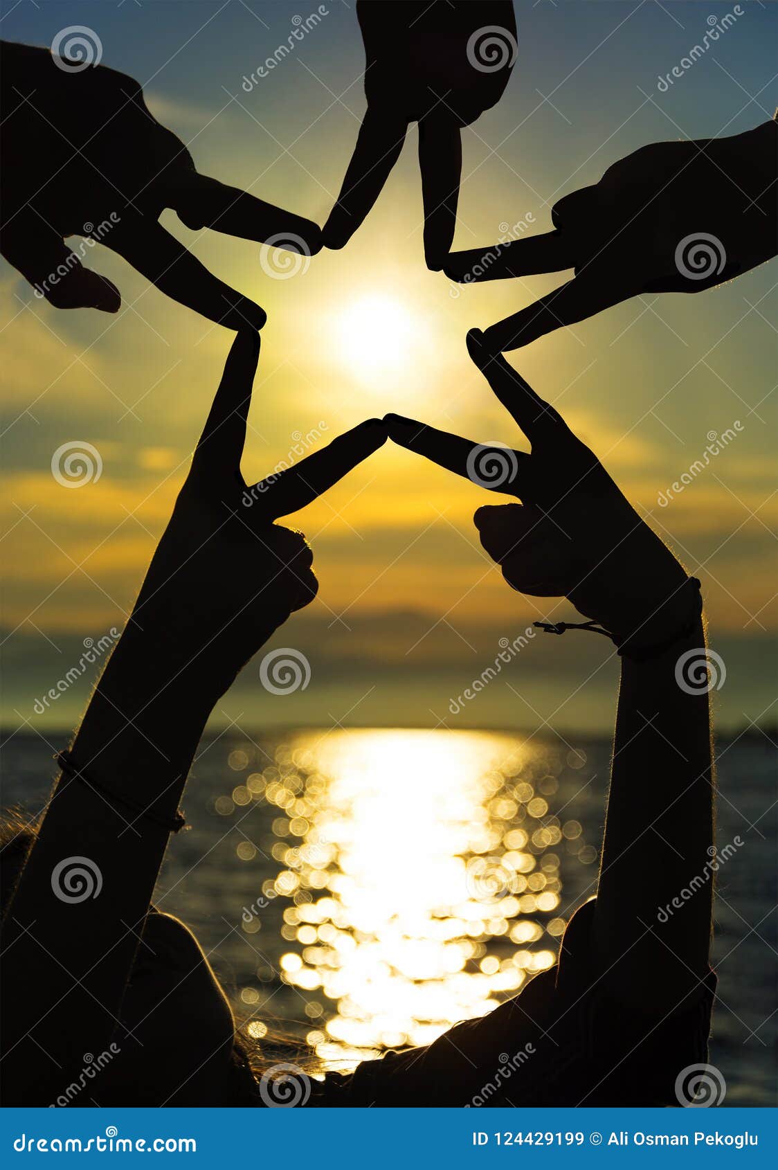 many hands connecting to star  at sunset, teamwork concept