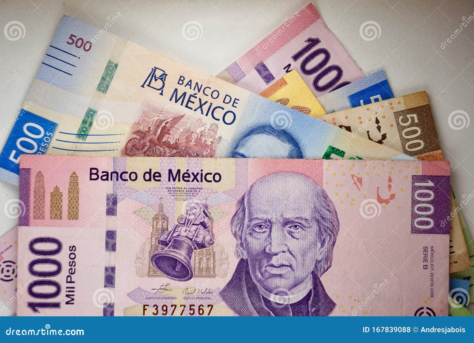 mexican pesos bills spread randomly over a flat surface