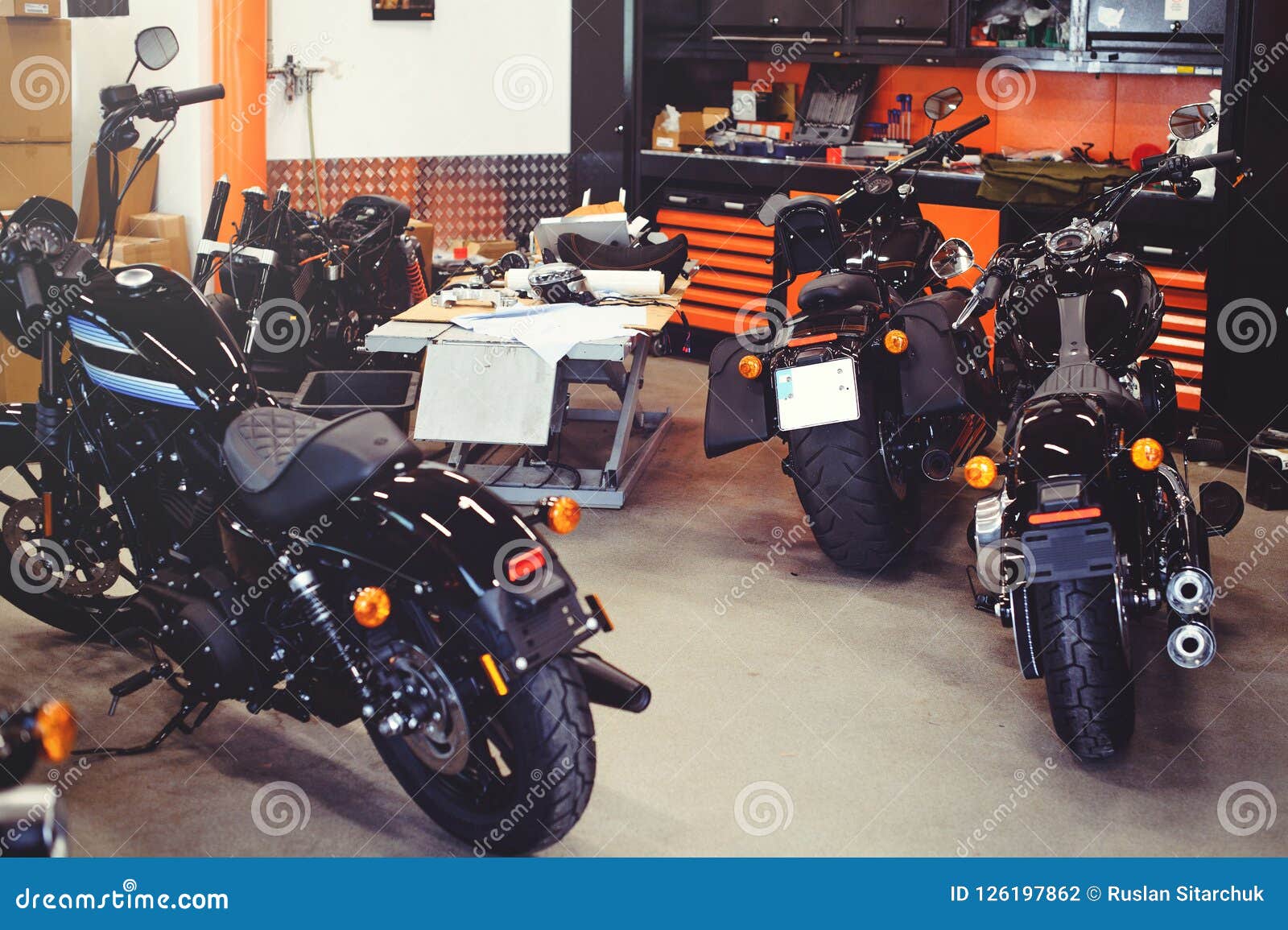 Many Motorcycles On The Floor With Workshop Tools A Modern Garage