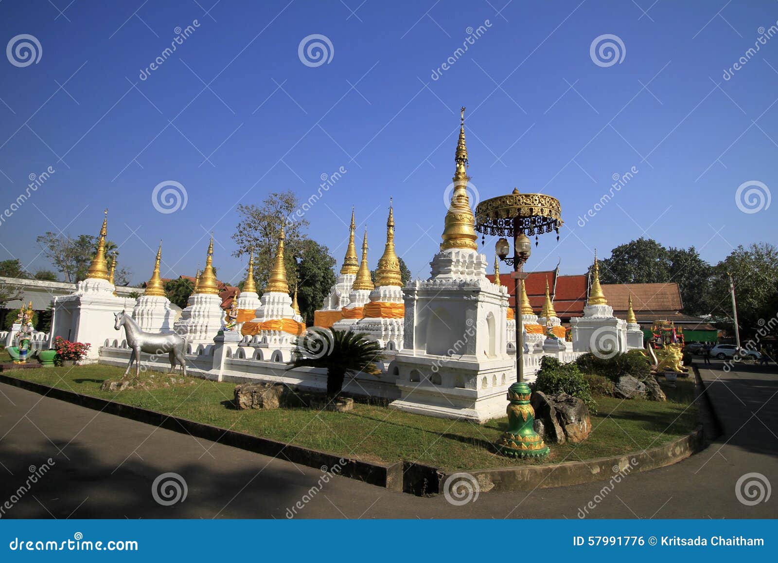 many pagodas with beep blue sky at wat-chedi-sao-lang, lampang