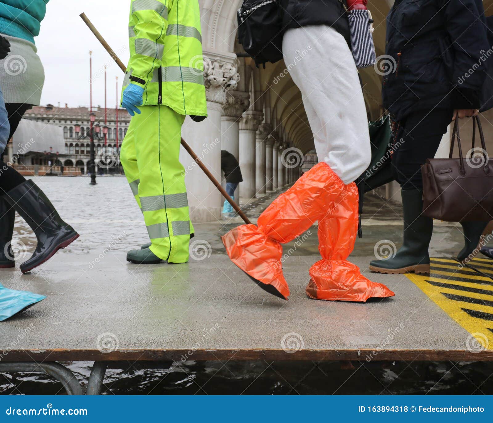 many people on the footbridge with plastic gaiters in venice in