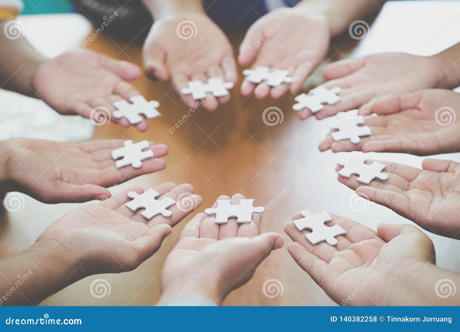 many persons holding pieces of jigsaw puzzle,teamwork concept,,business connection,success and strategy concept,business accountin