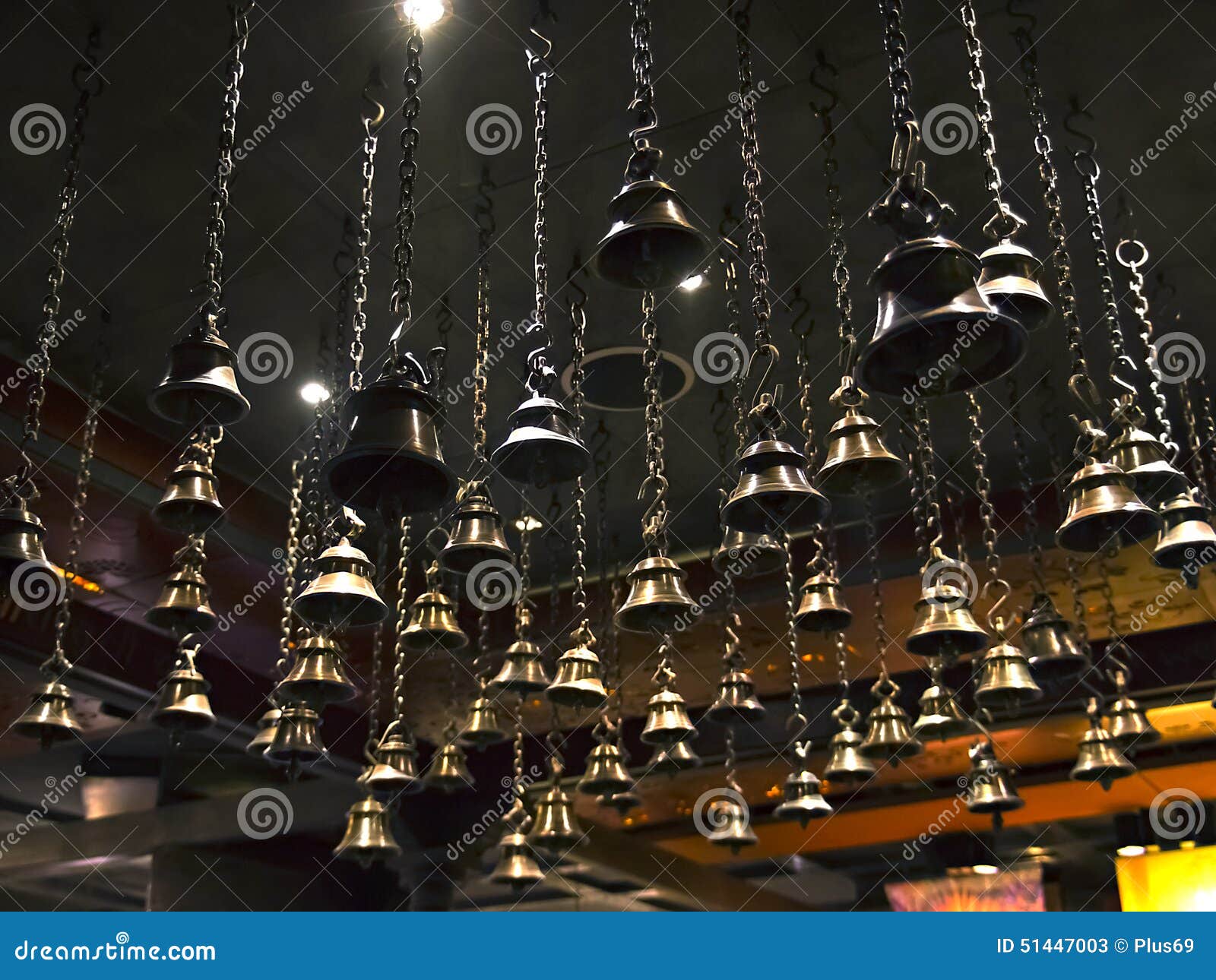 Many Ritual Bells Hanging on Chains from the Ceiling Stock Image