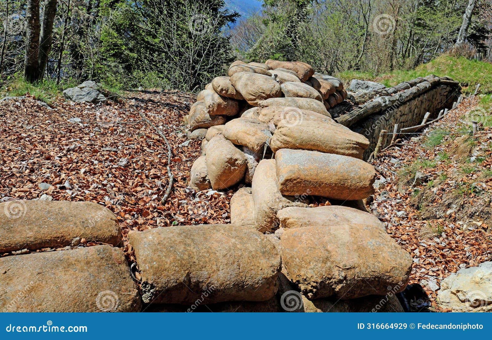 many sandbags of a trench dug in the ground to defend army soldiers from enemy raids