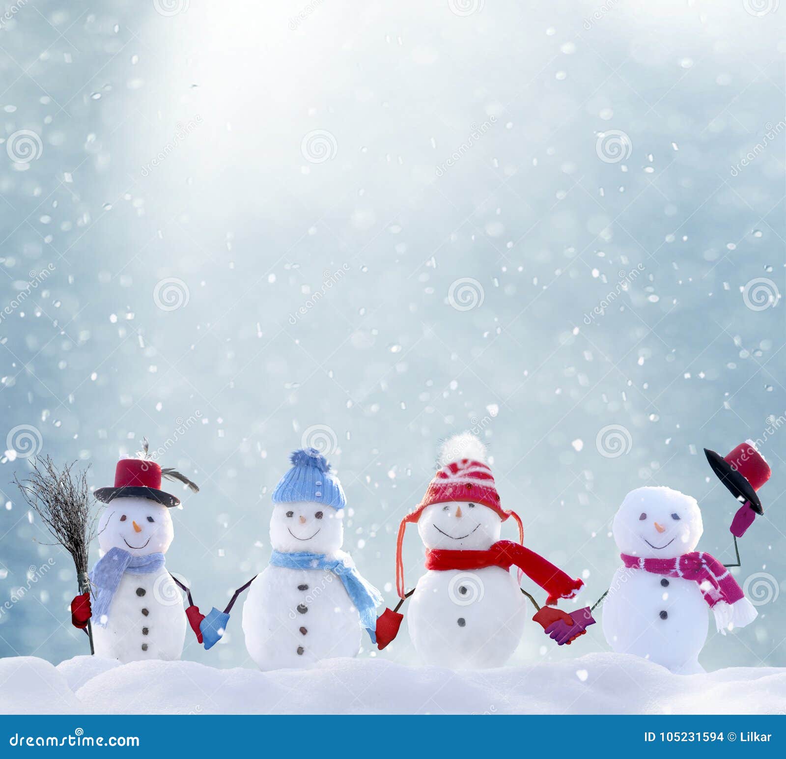 many snowmen standing in winter christmas landscape