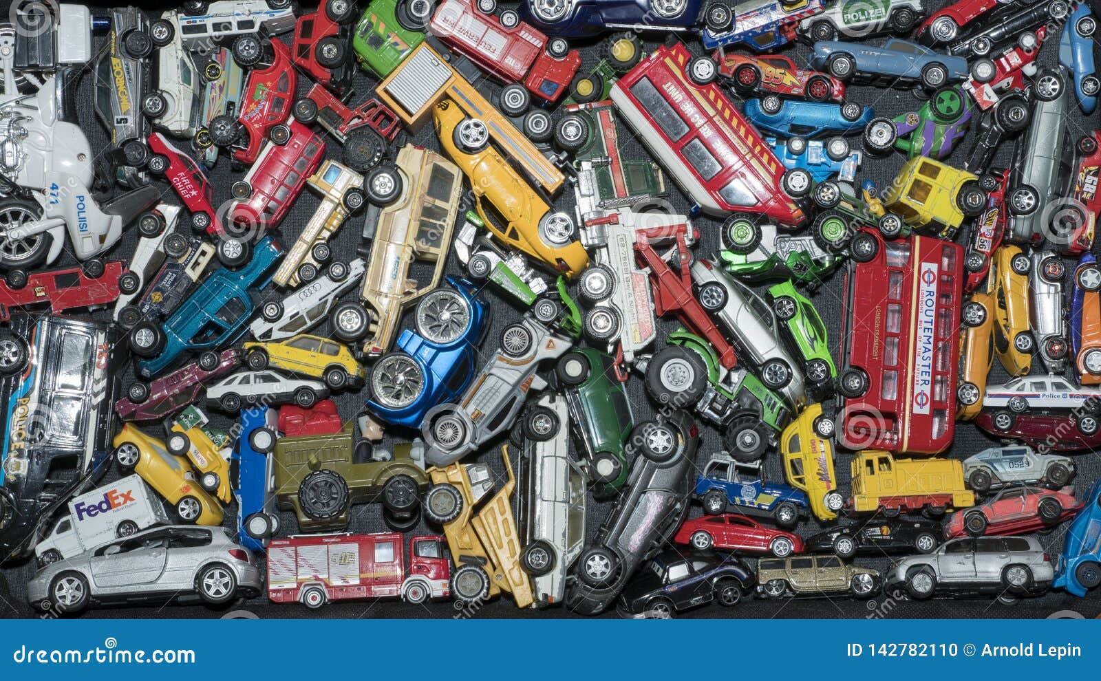 Many Toy Cars. Photo of Multicolored Toy Cars in an Old Suitcase Stock