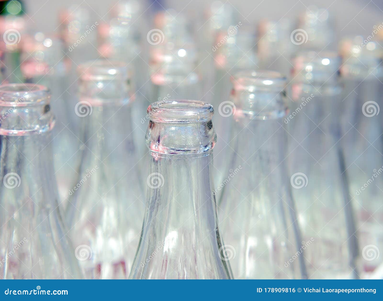many used glass bottles arranged in rows.recyclable object image