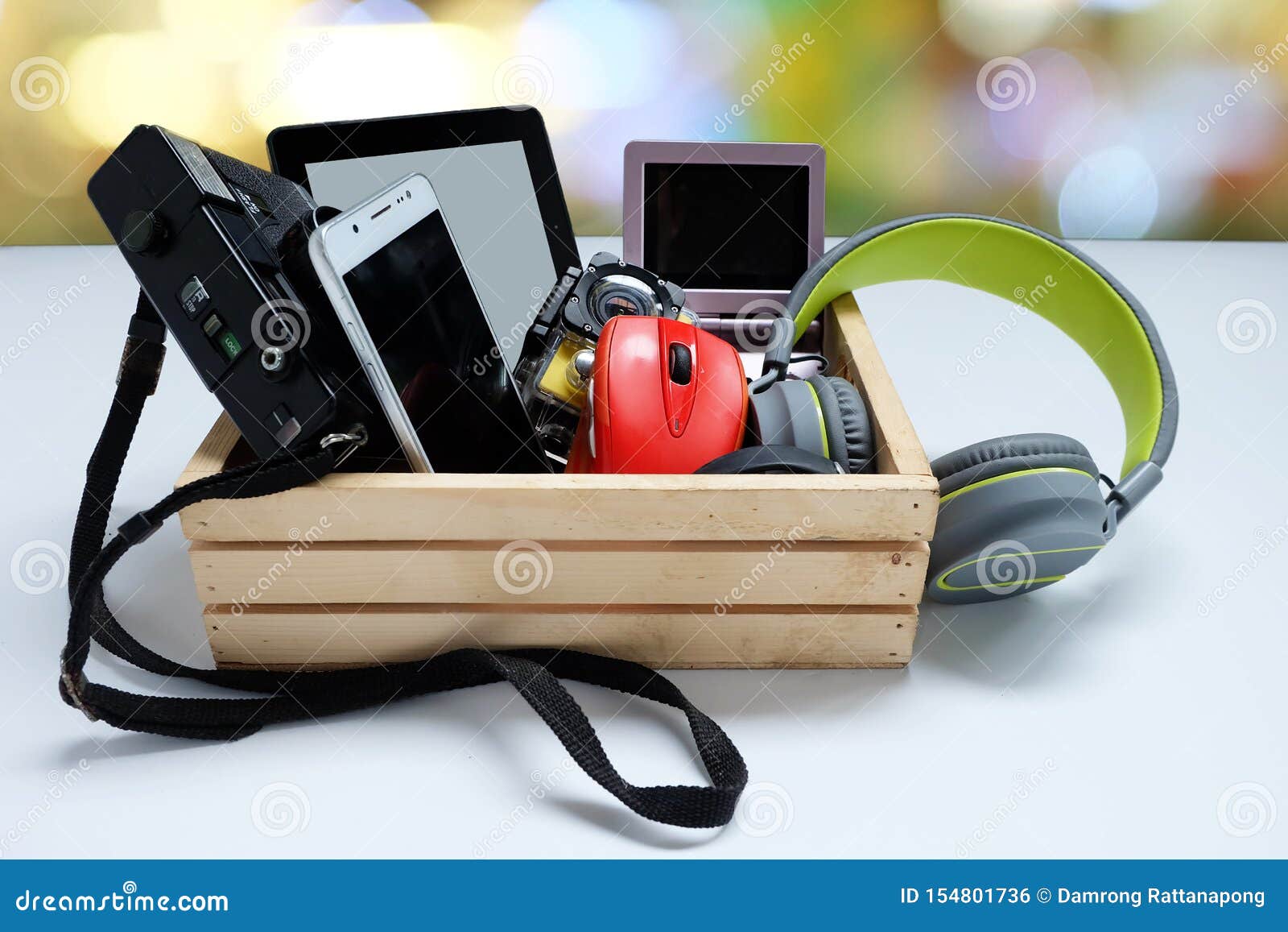 many used modern electronic gadgets for daily use in wooden cases on white background