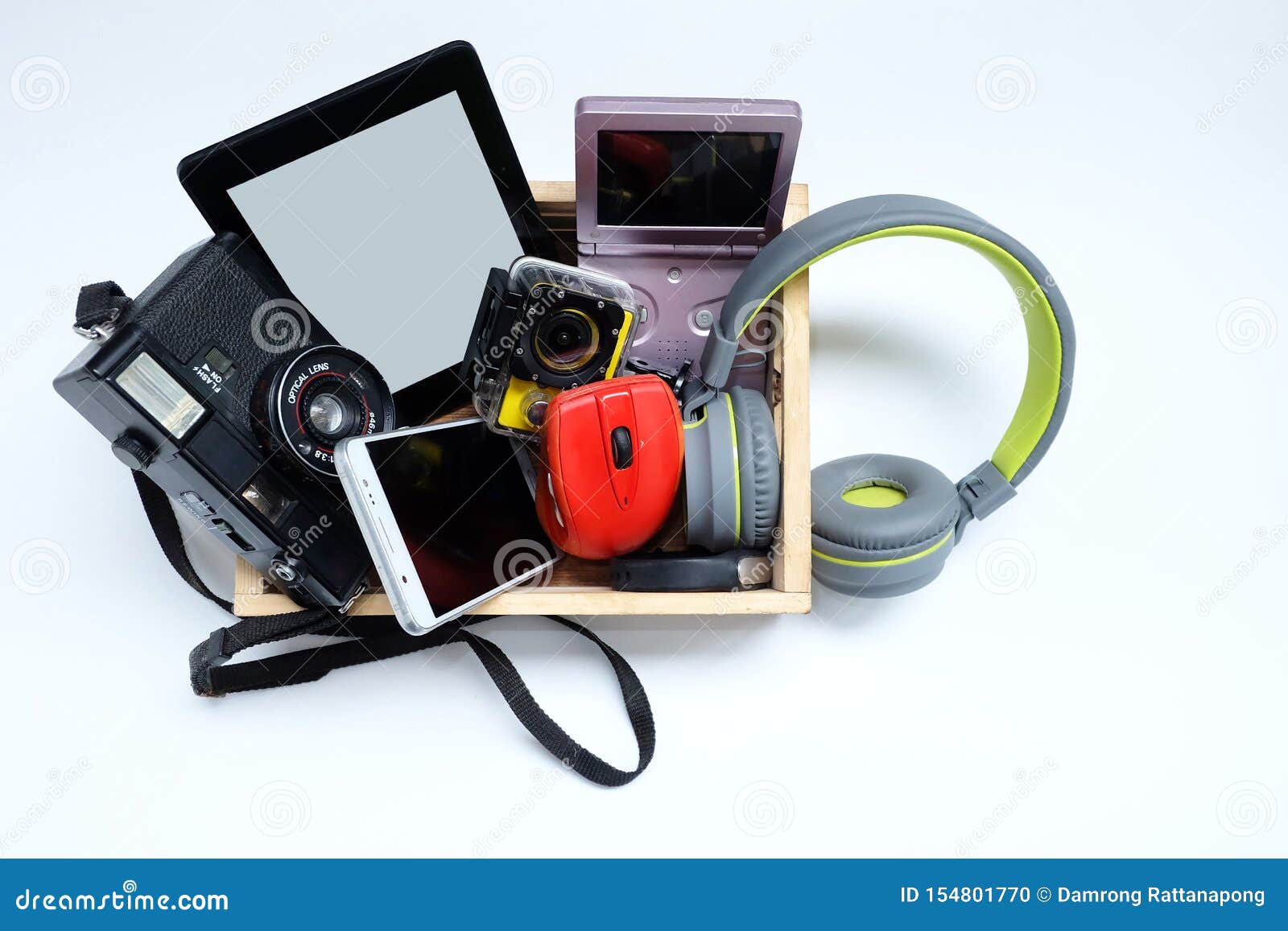 many used modern electronic gadgets for daily use in wooden cases on white background