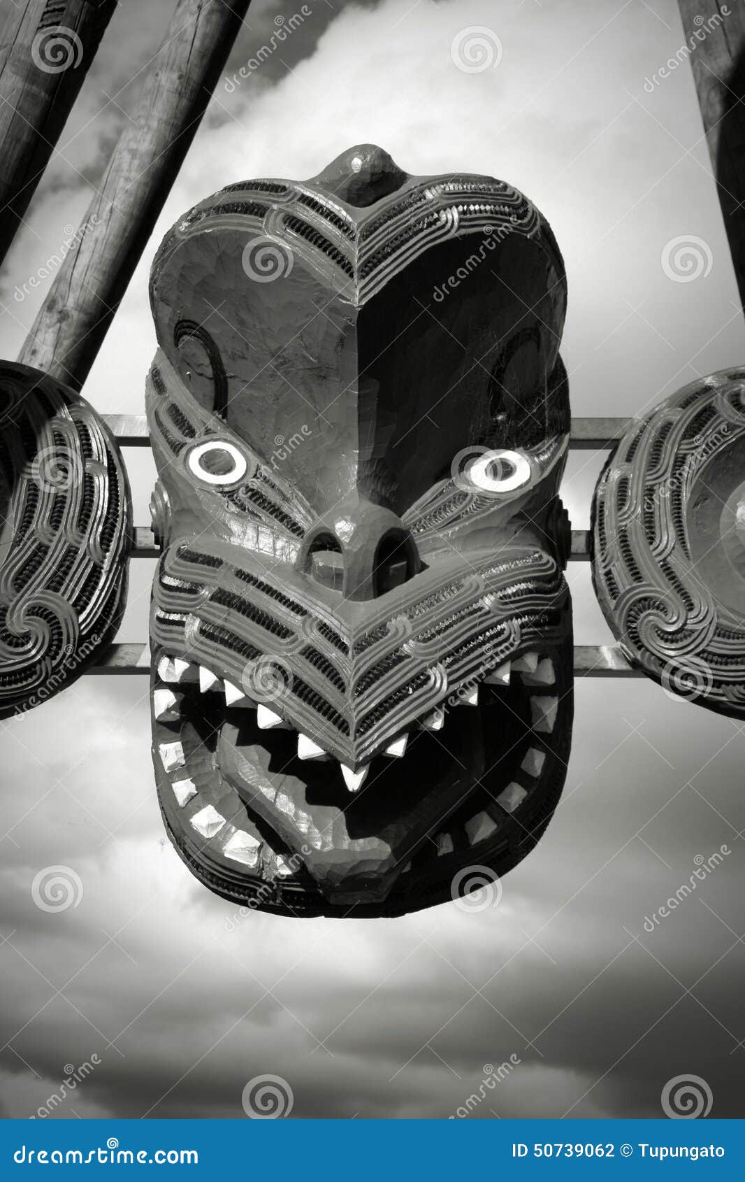 Maori style mask. Maori mask carving - face carved in the wood. Rotorua, New Zealand. Black and white tone - retro monochrome color style.