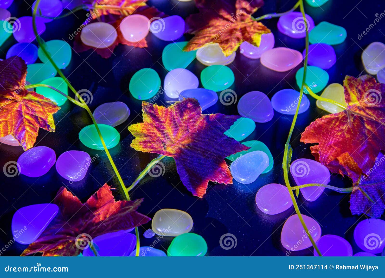 Maple Leaves Made of Plastic on a Colored Stone Background Stock Photo