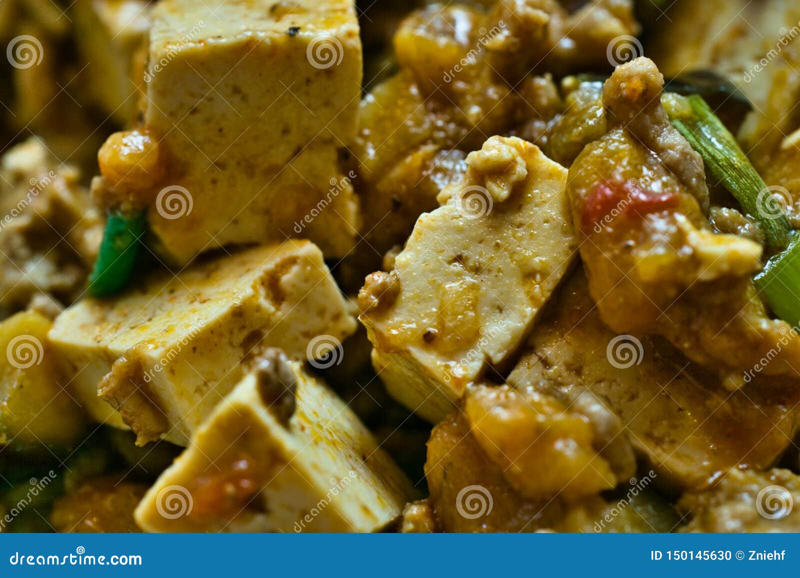 mapo doufu also known as mapu tofu, a spicy asian dish made from minced meat and tofu cubes with spring onions and lots of chili,