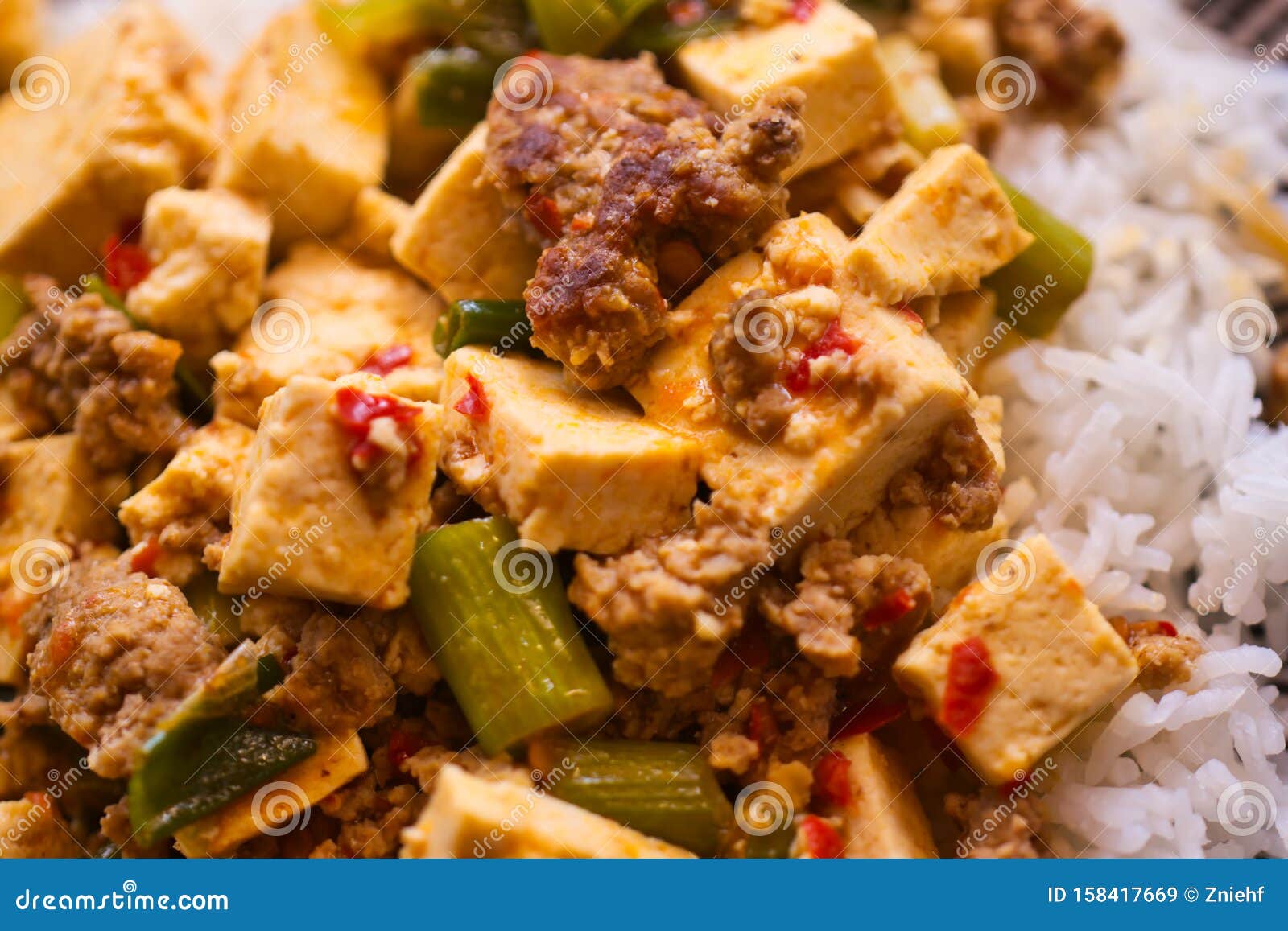 mapo doufu also known as mapu tofu, a spicy asian dish made from minced meat and tofu cubes with spring onions and lots of chili,