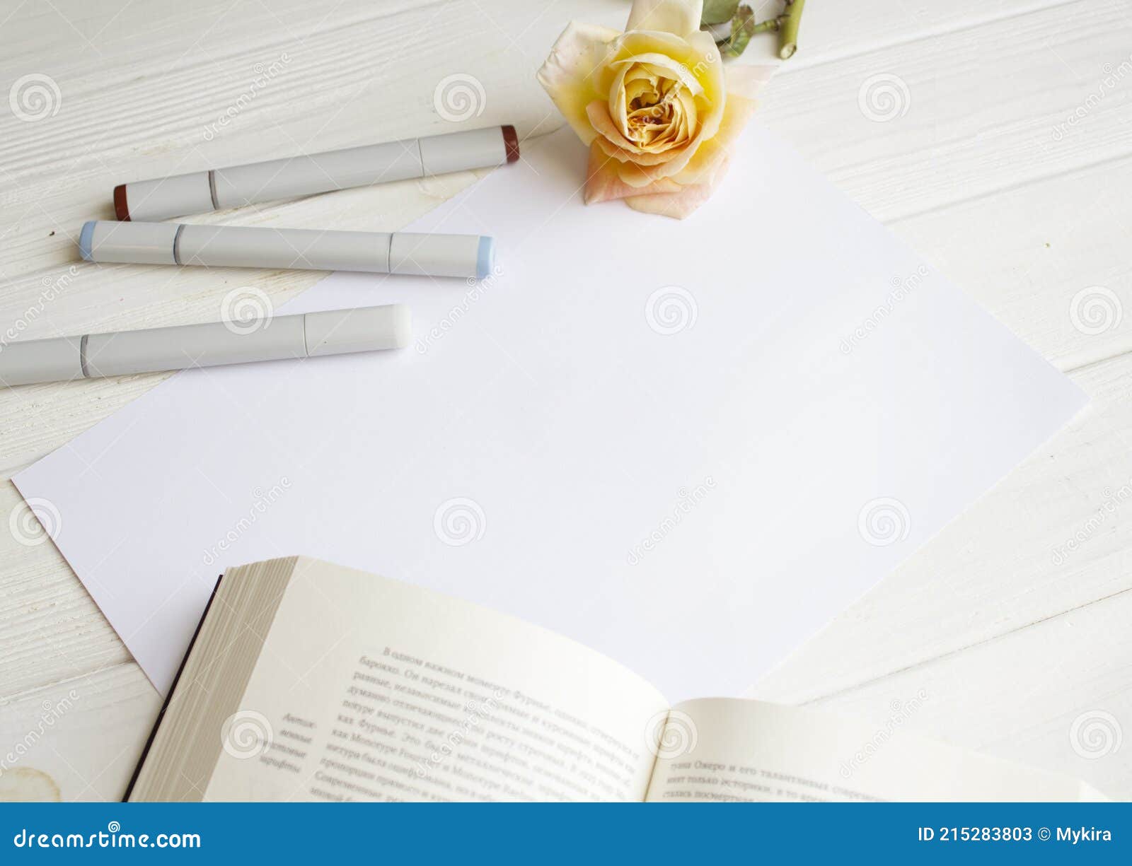 https://thumbs.dreamstime.com/z/maquette-pour-papier-avec-livre-rose-unique-et-mat%C3%A9riel-de-dessin-sur-bois-blanc-mod%C3%A8le-ou-d-affiche-215283803.jpg