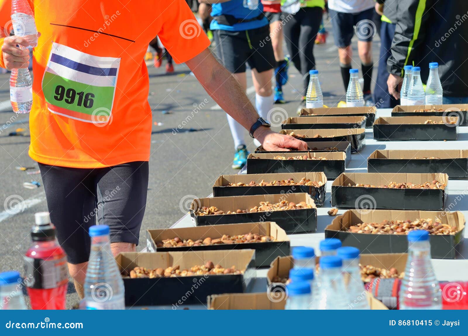 marathon running road race, runners hand taking food and drinks on refreshment point, sport, fitness and healthy lifestyle