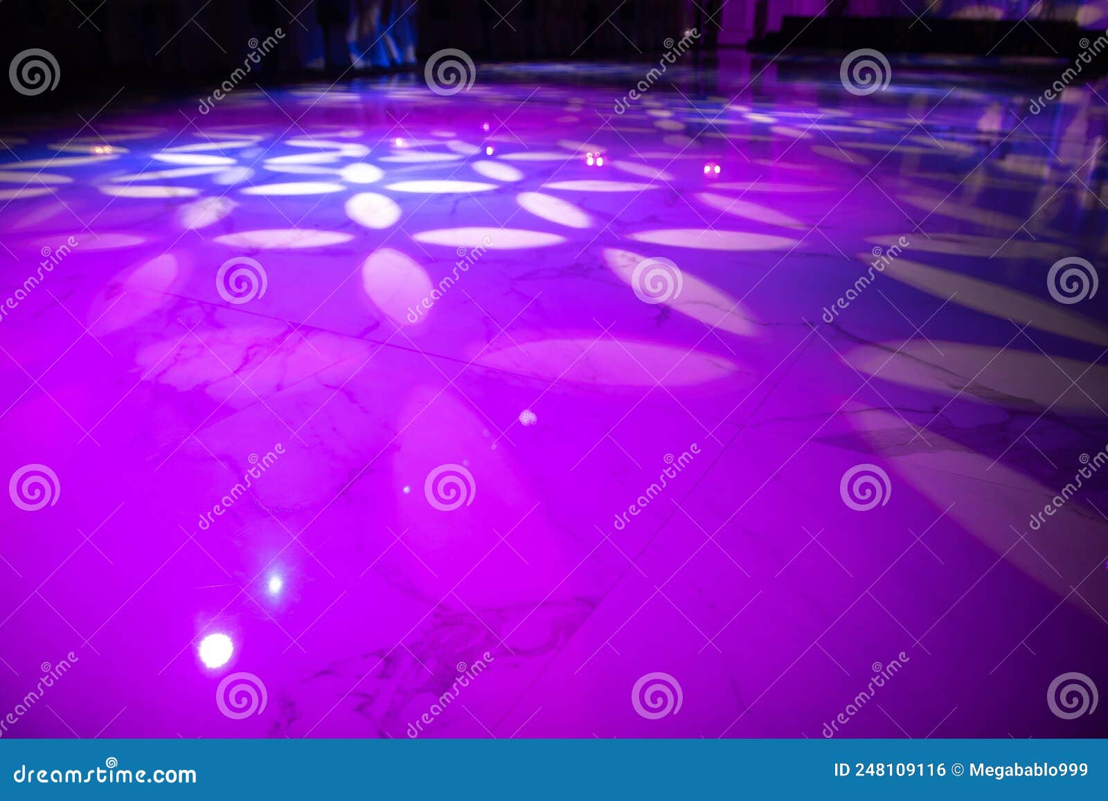The Marble Dance Floor is Flooded with Professional Lighting Equipment with Gobo Nozzles that