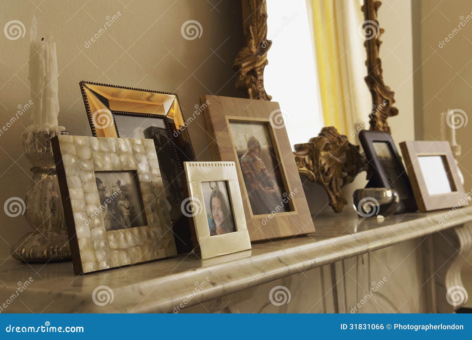 marble fireplace mantel with framed pictures and mirror