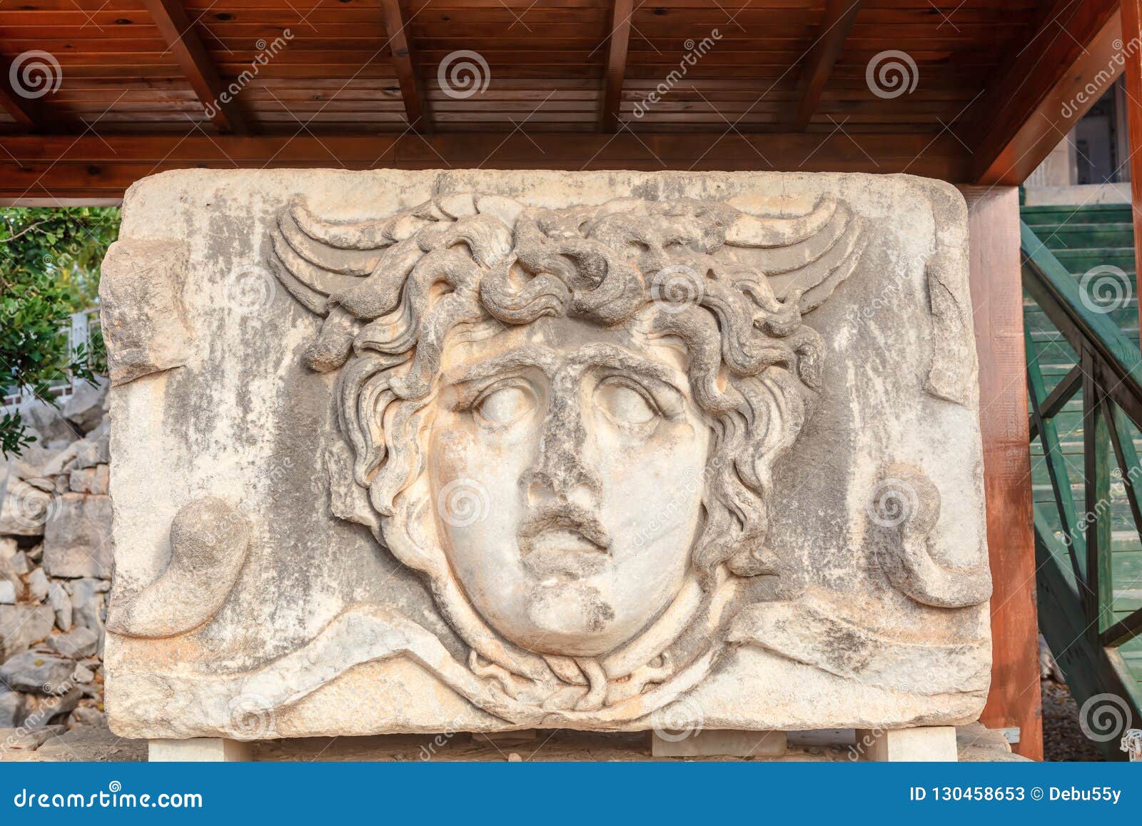 marble tablet with ancient stone carving of medusa head.