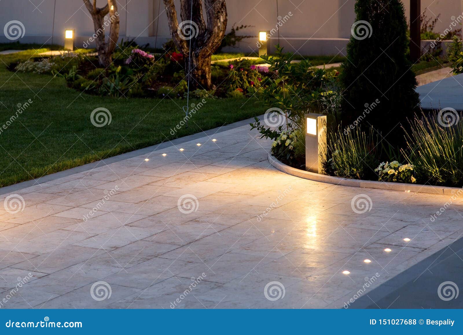 marble tile playground in the backyard of flowerbeds and lawn with ground lantern.