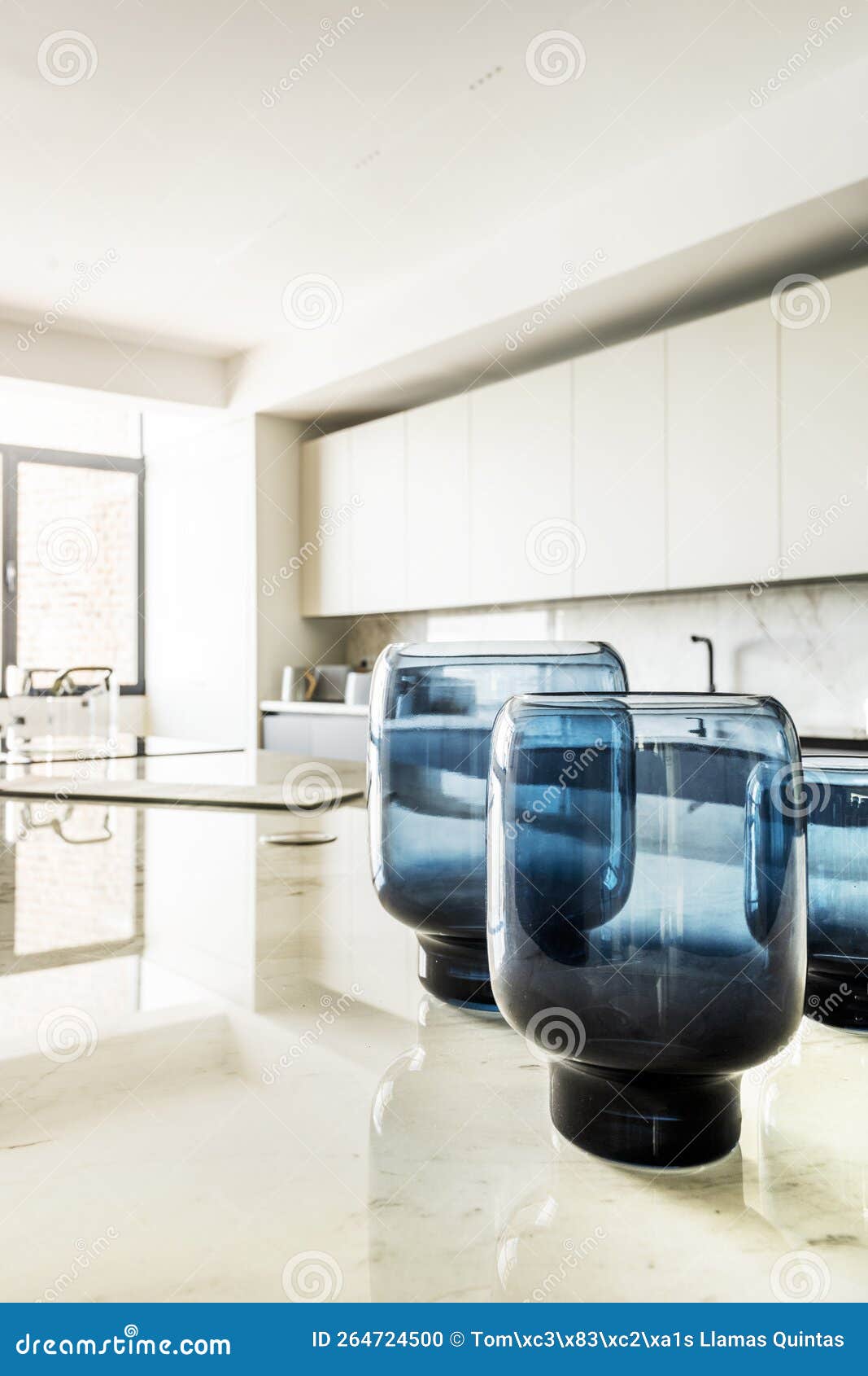 Marble Top of a Kitchen Island with Blue Glass Vases Stock Photo