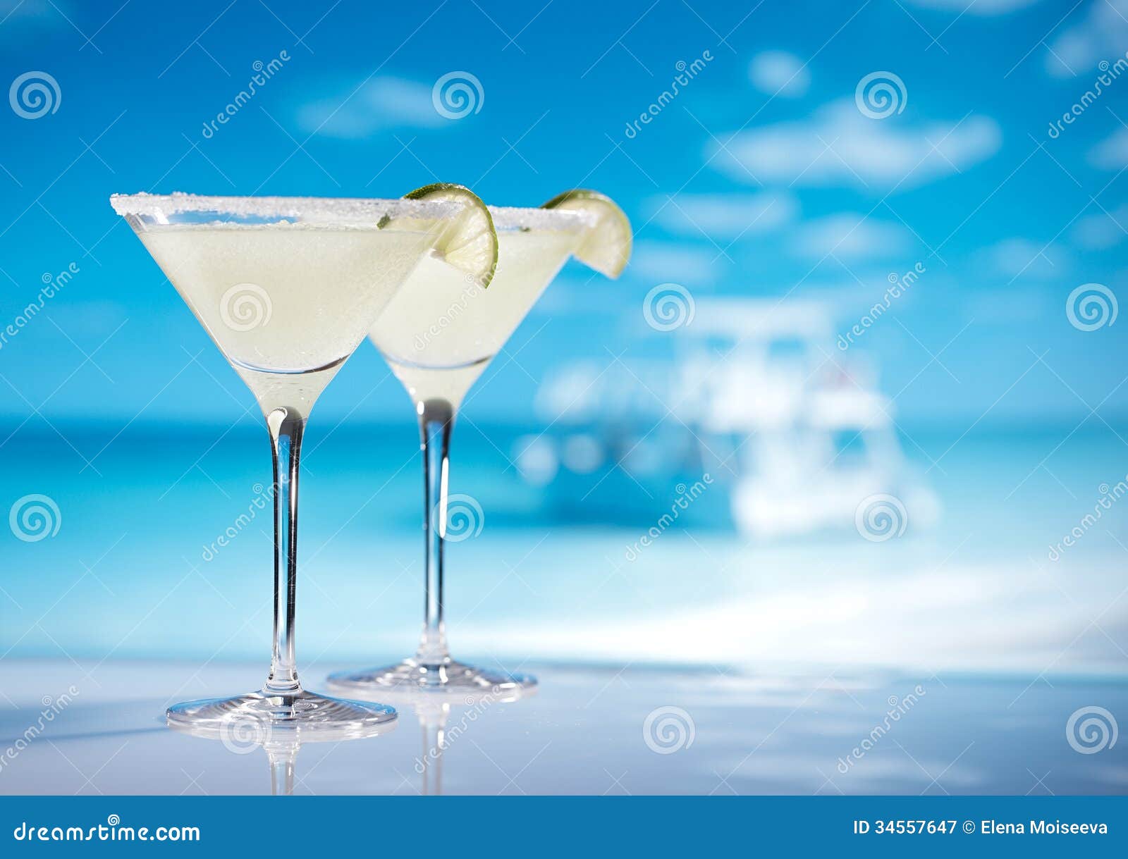 margarita cocktail on beach, blue sea and sky background