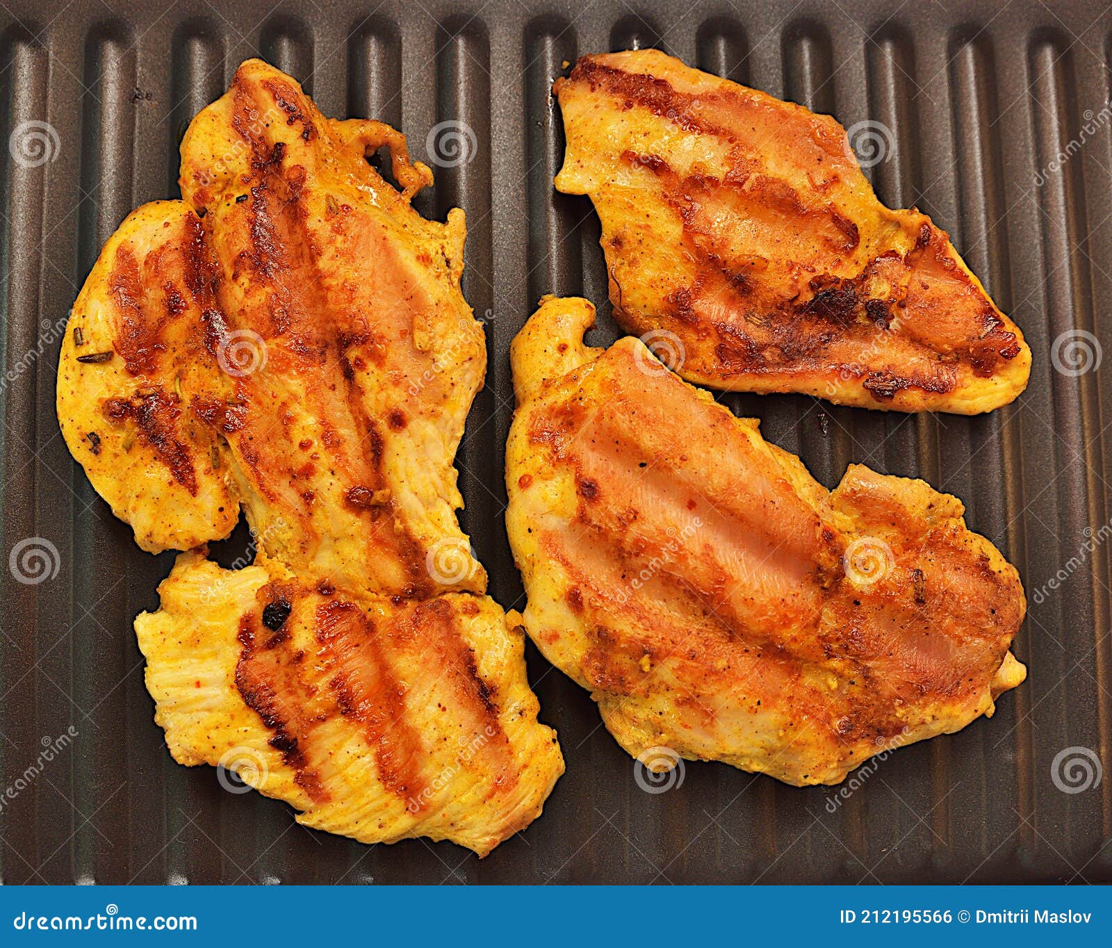 Marinated Chicken Fried on an Electric Grill Baking Sheet. Stock Photo