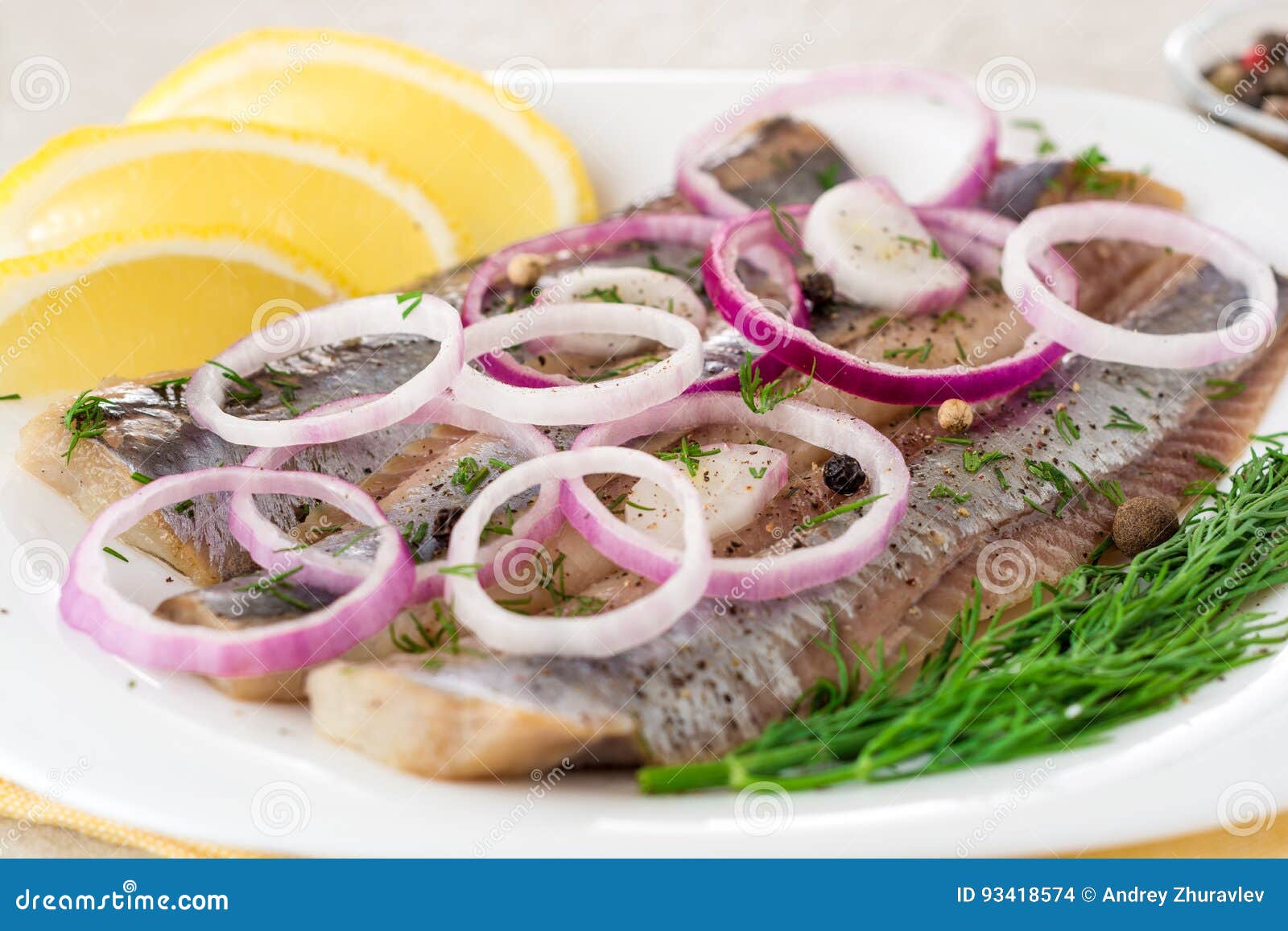 Marinated Herring Fillets with Red Onion, Dill and Spices on White