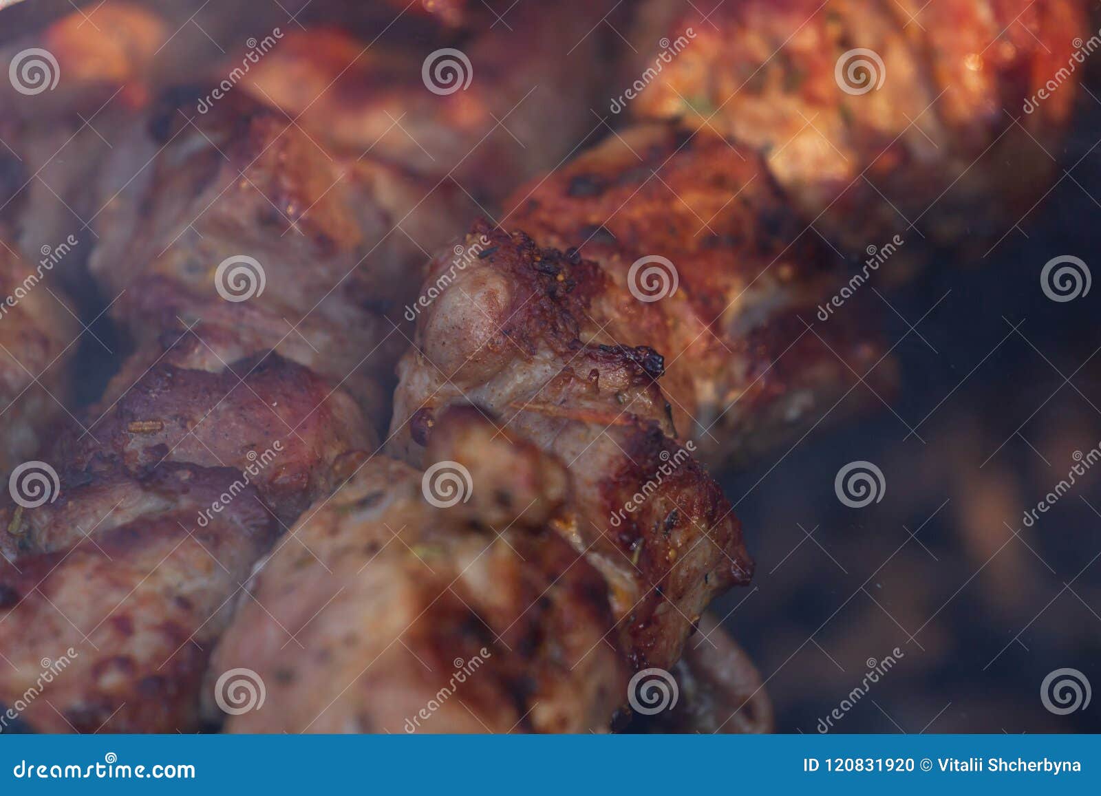 marinated shashlik preparing on a barbecue grill over charcoal. shashlik or shish kebab popular in eastern europe. shashlyk, skewe
