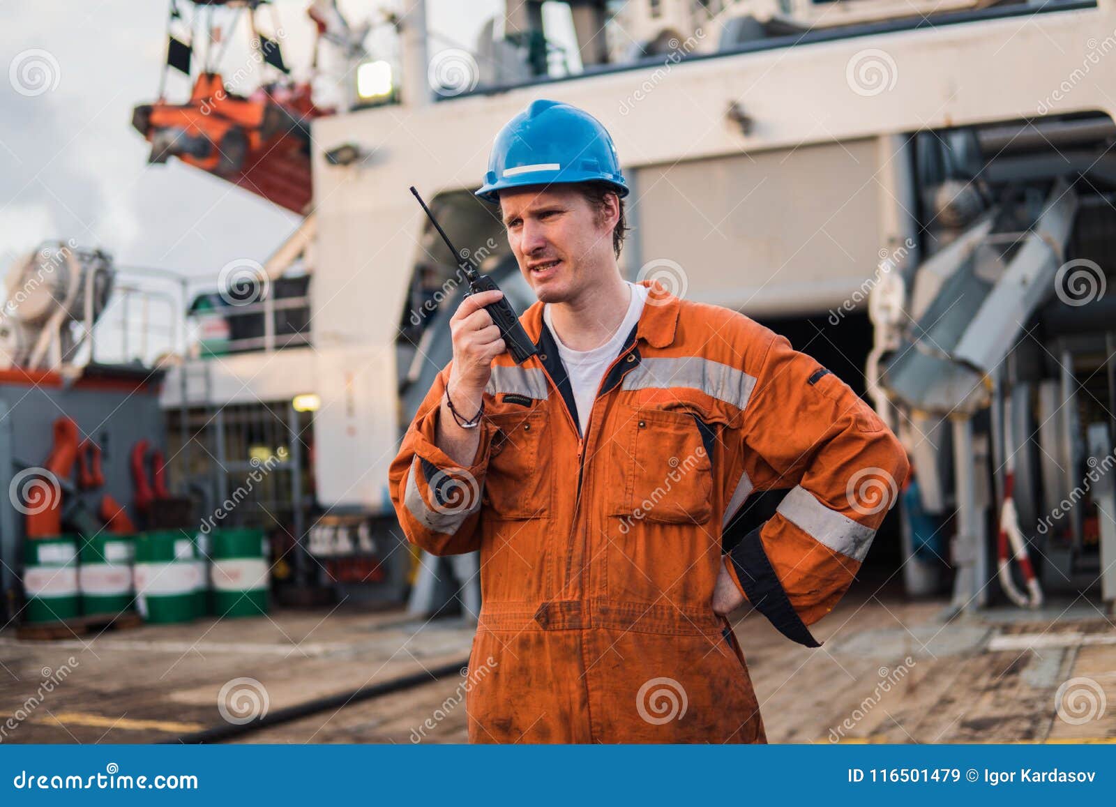 marine deck officer or chief mate on deck of ship with vhf radio