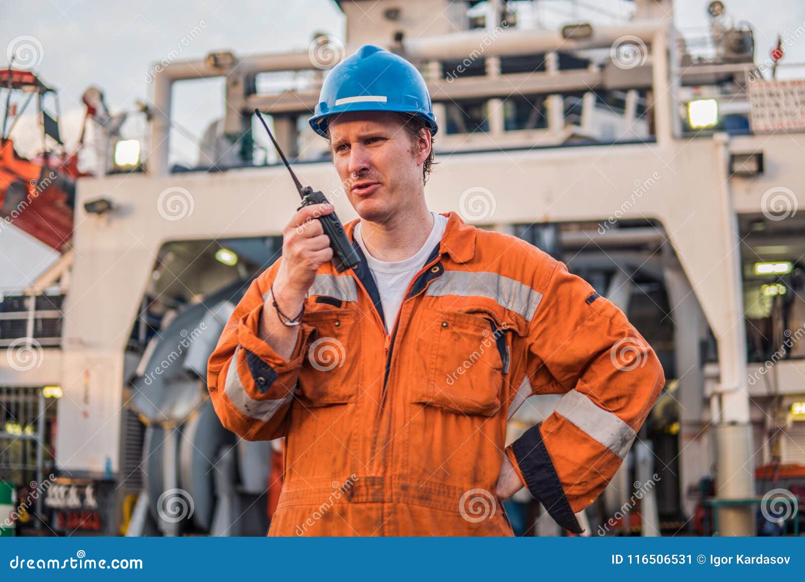 marine deck officer or chief mate on deck of ship with vhf radio