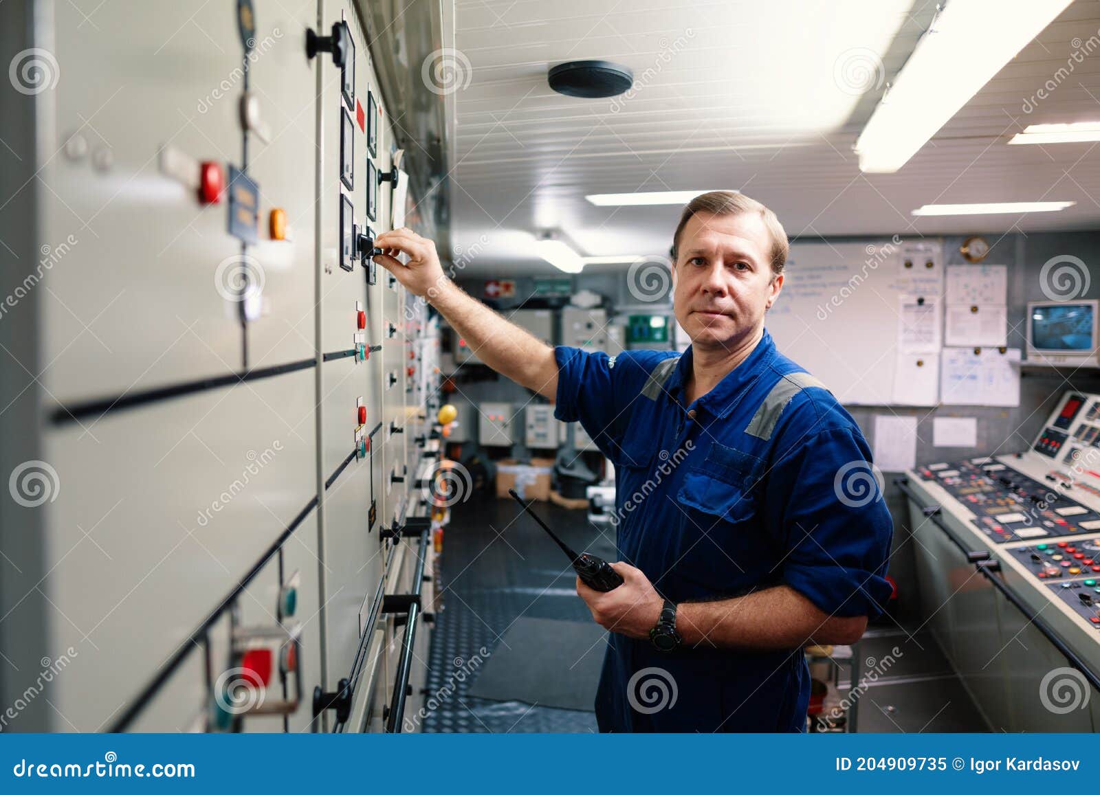 marine engineer officer controlling vessel engines and propulsion in engine control room